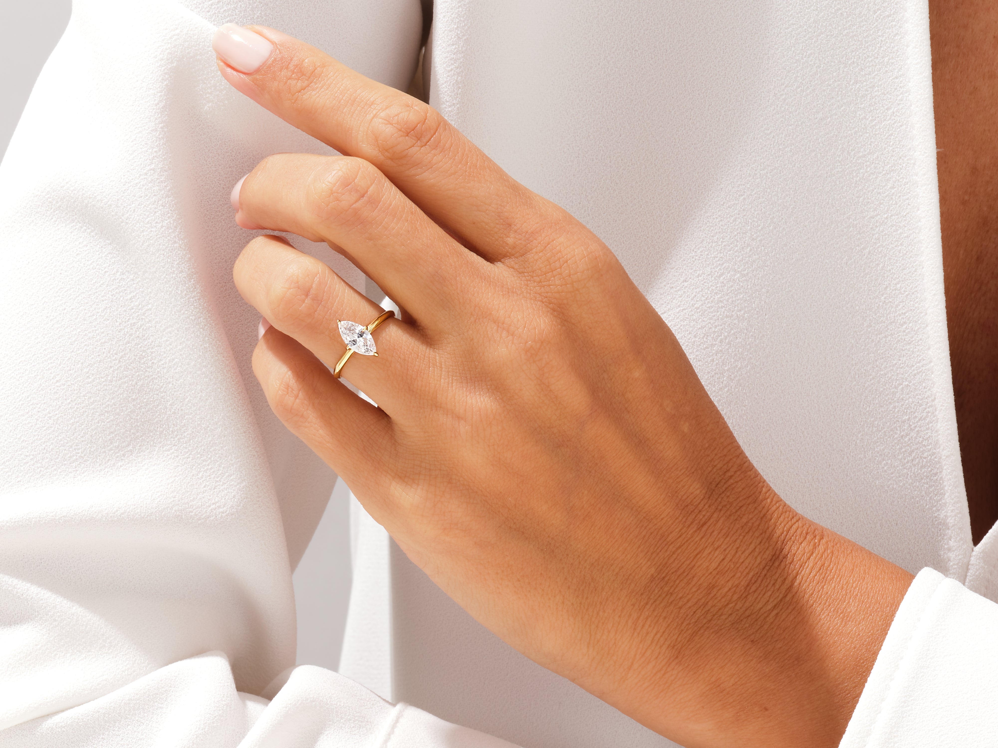 Marquise diamond engagement ring on a hand, fine jewelry