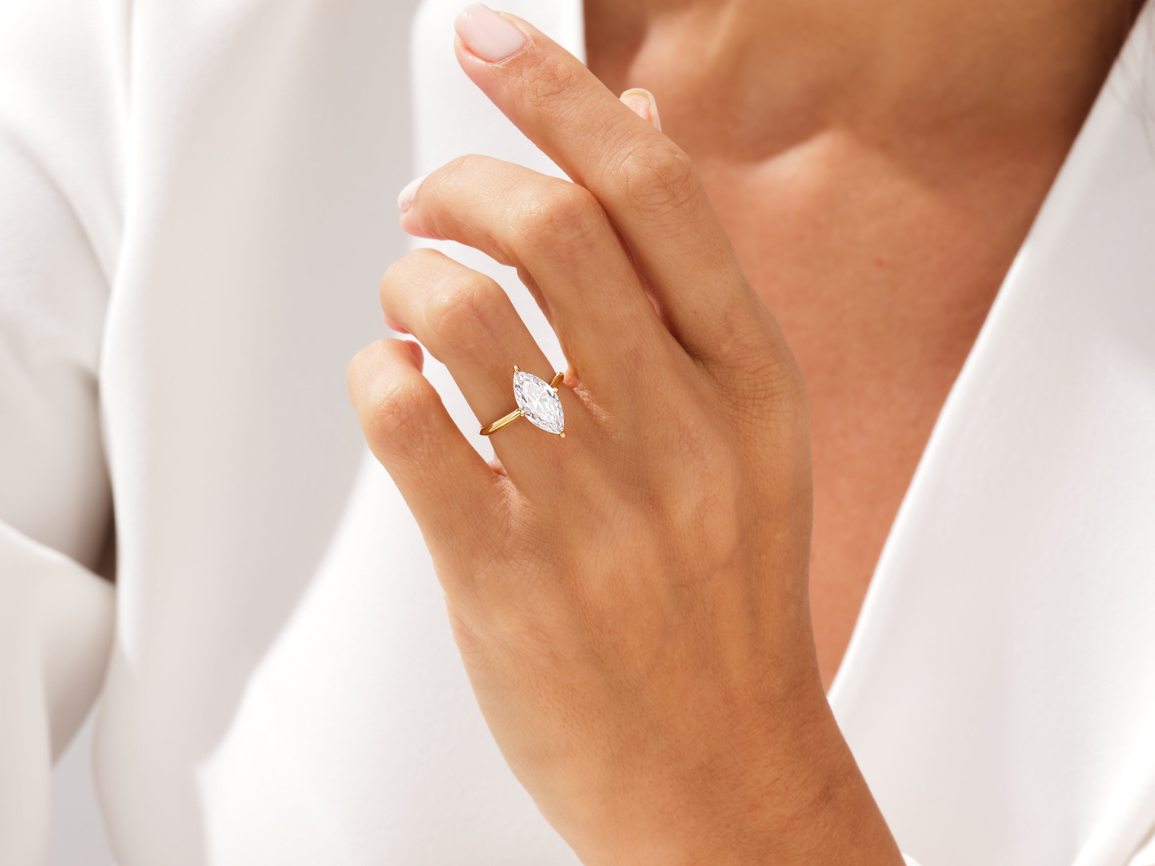 Marquise diamond engagement ring on a woman's hand
