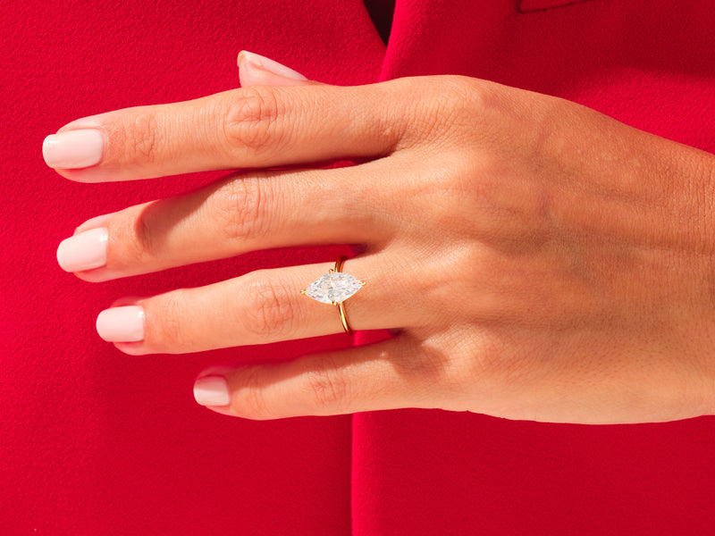 Marquise diamond engagement ring on a hand, jewelry