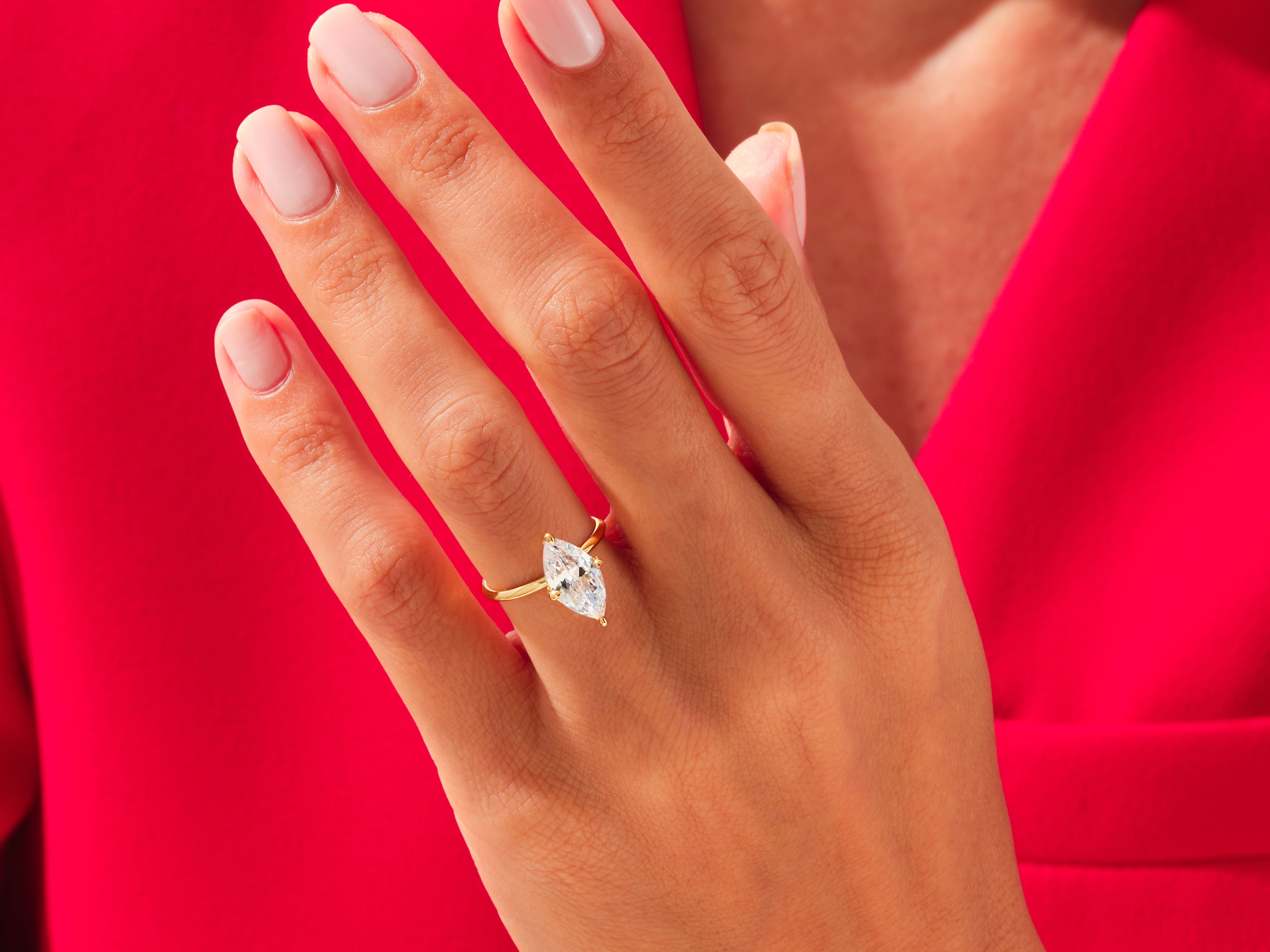 Marquise diamond engagement ring on hand, luxury jewelry