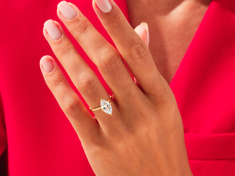 Marquise diamond engagement ring on hand, luxury jewelry