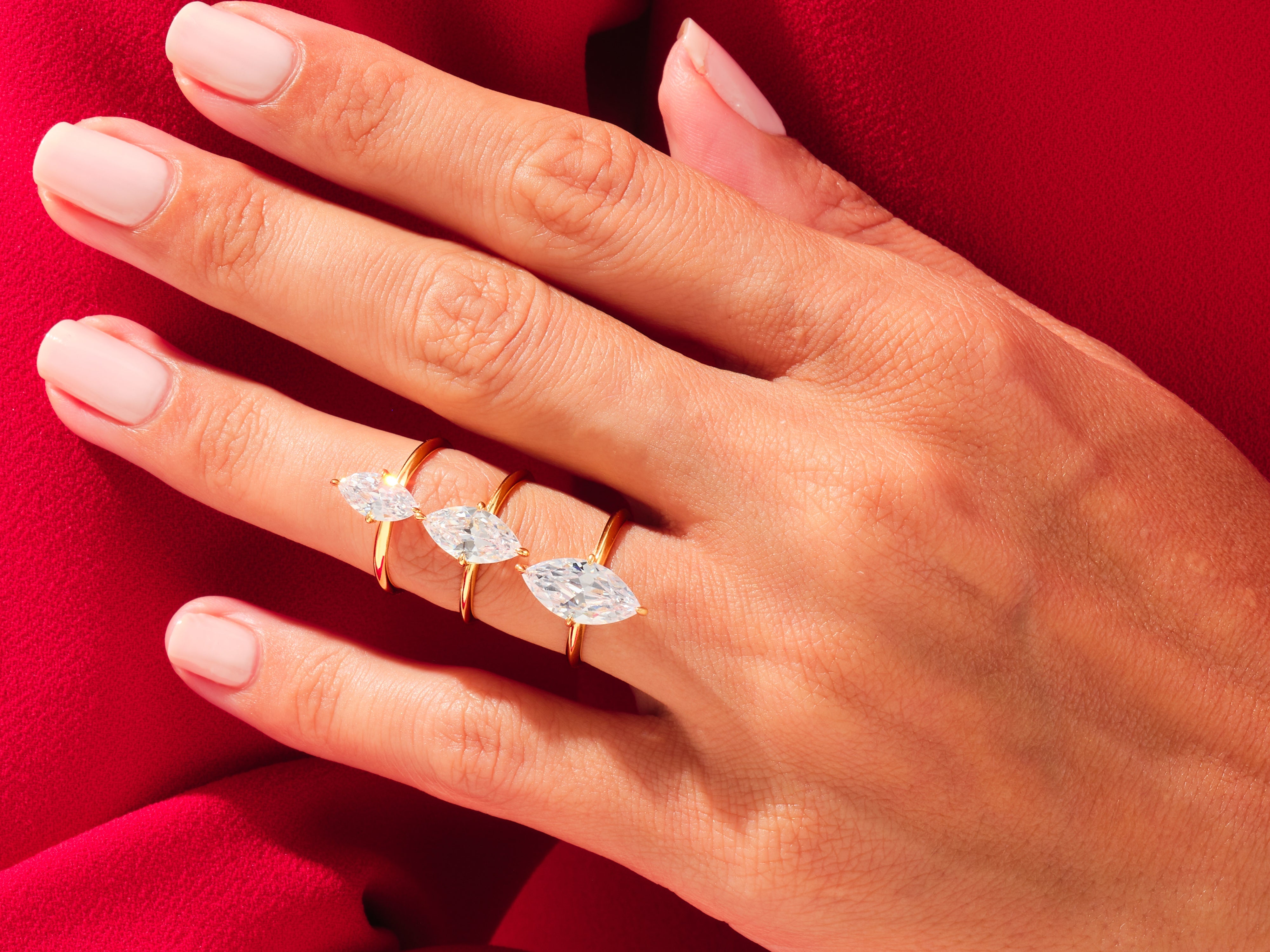 Three marquise diamond rings on a hand, jewelry photography