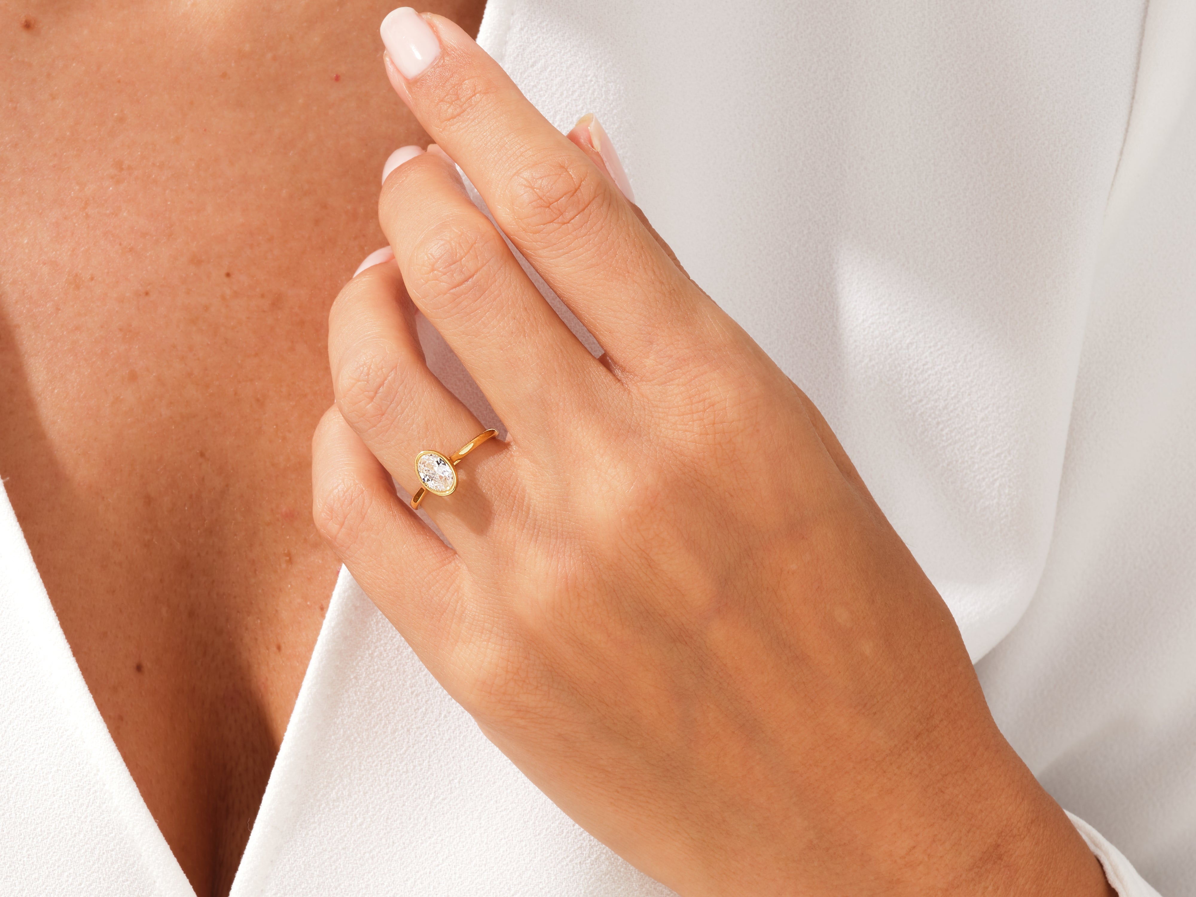 Gold oval diamond ring on a woman's hand