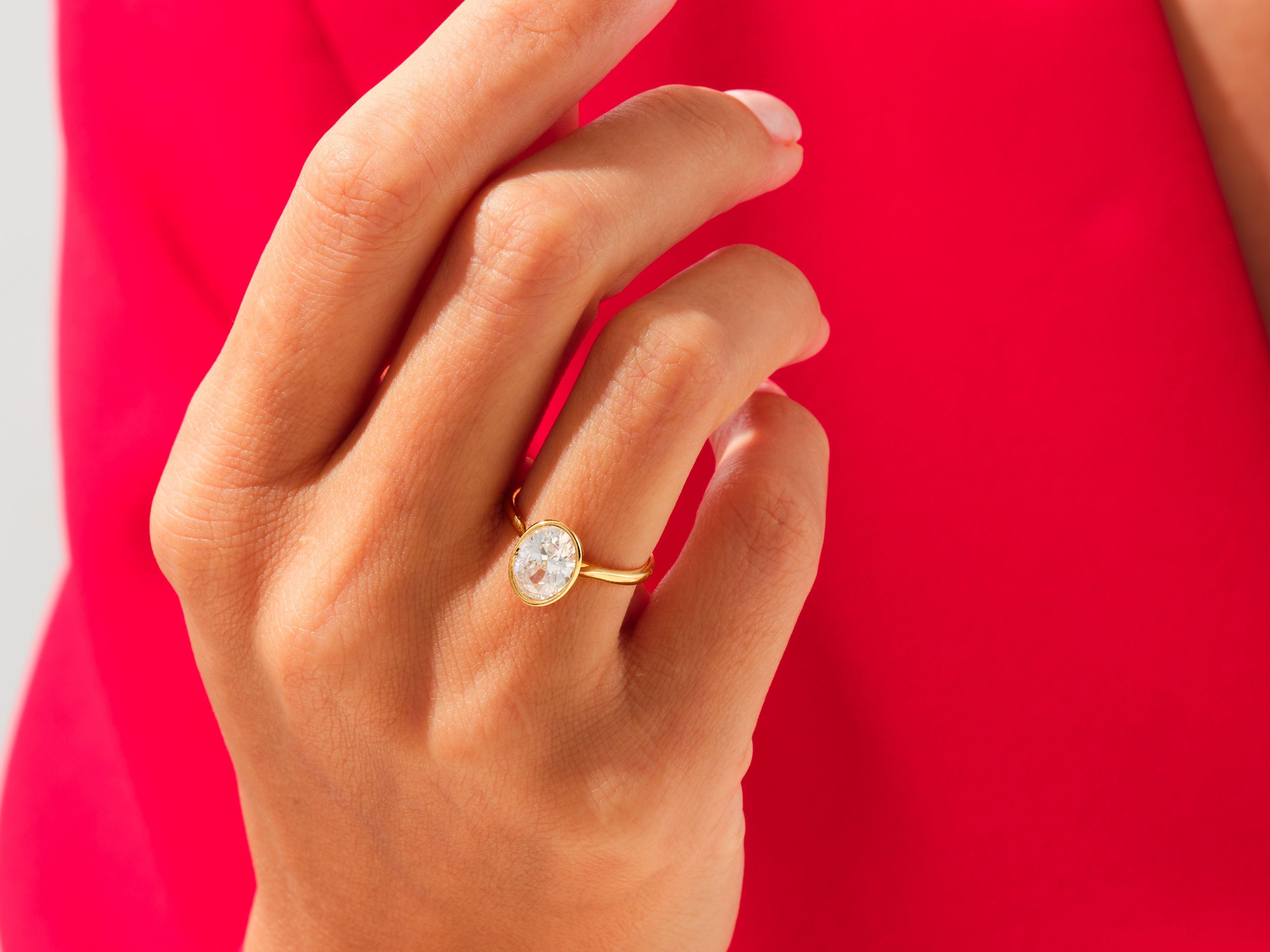 Gold oval diamond ring on hand, jewelry