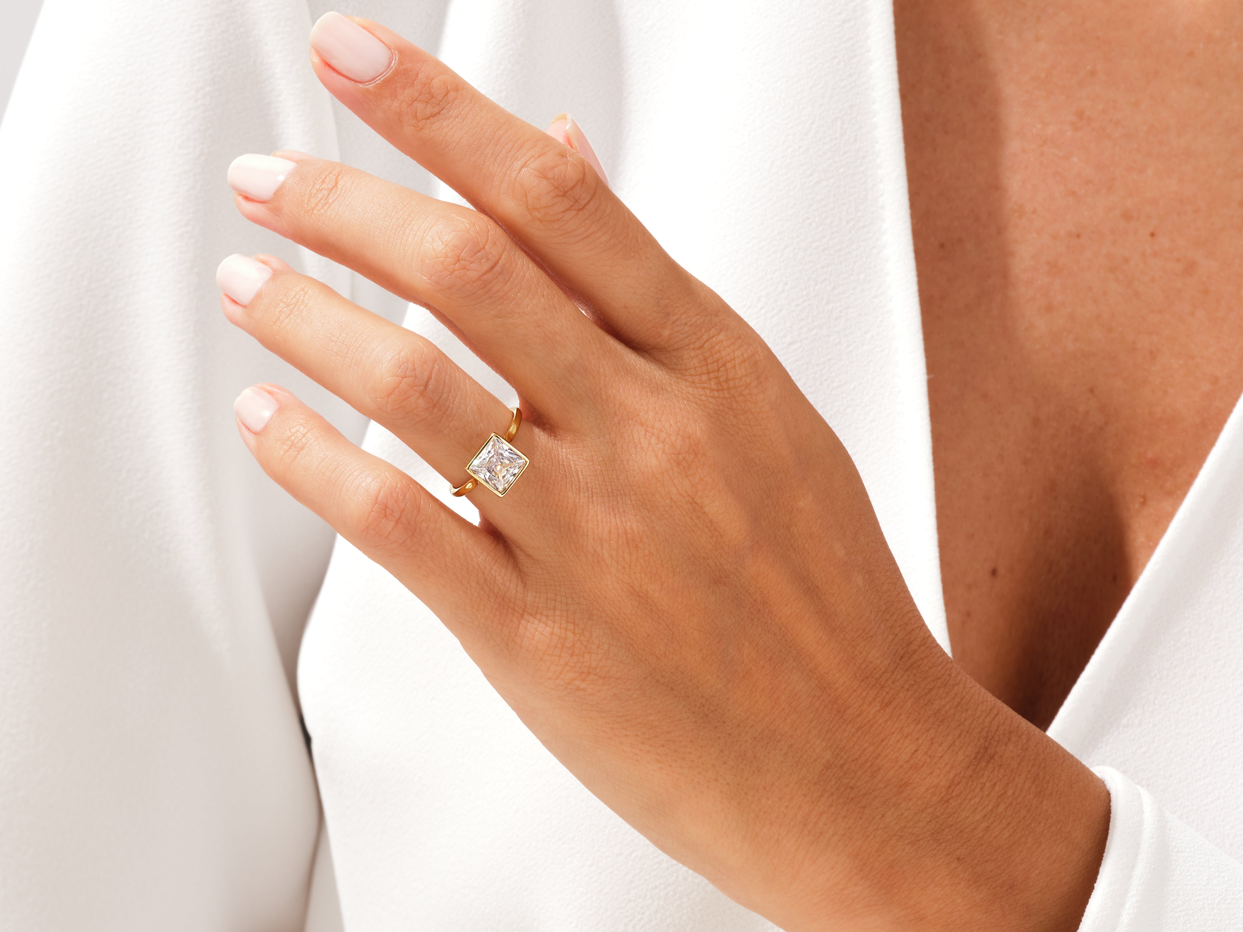 Gold ring with square diamond on hand