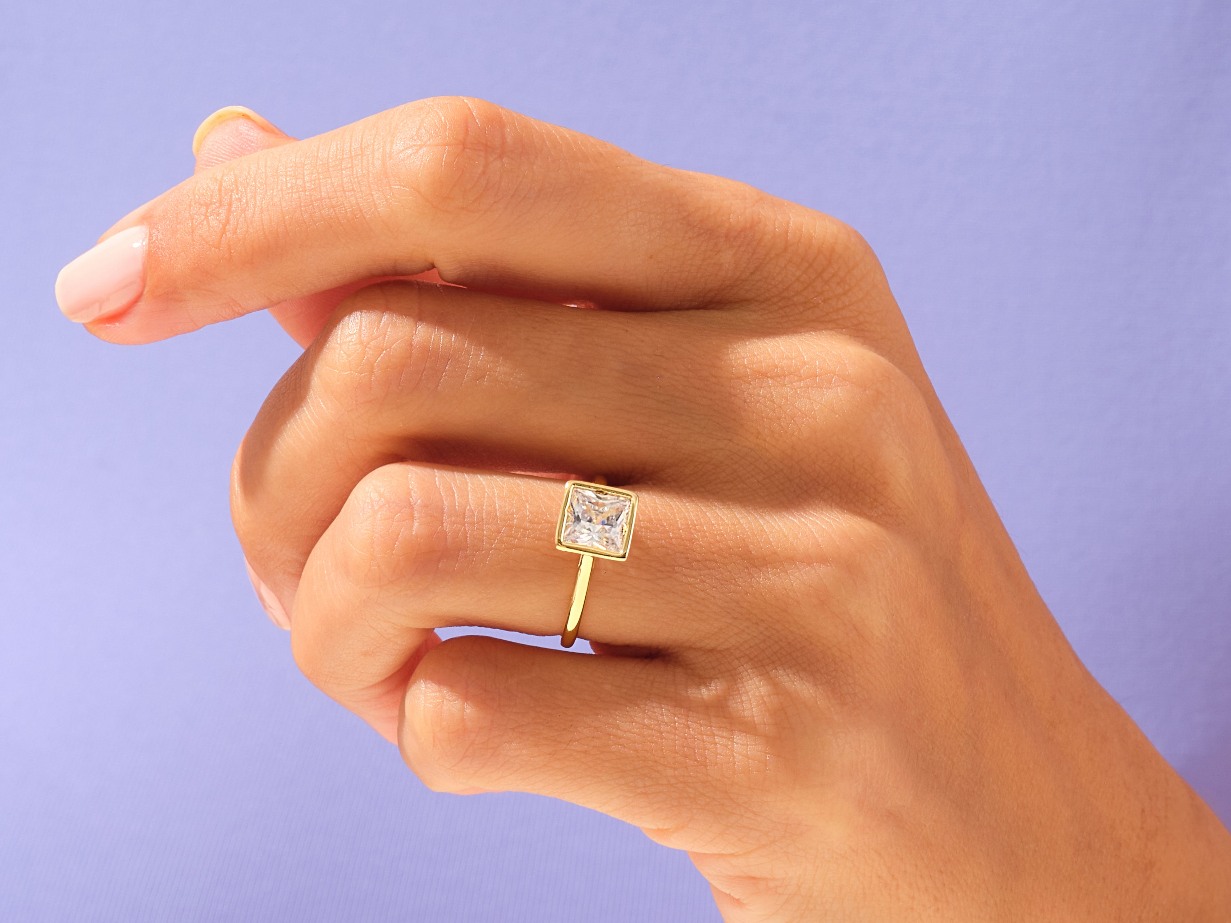 Gold ring with square diamond on hand
