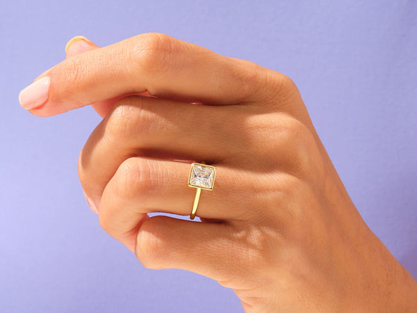 Gold ring with square diamond on hand