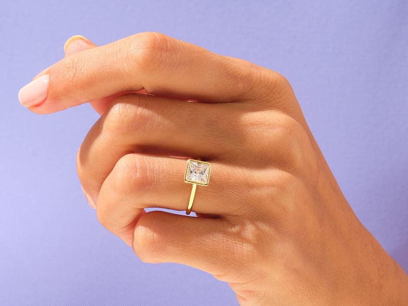 Gold ring with square diamond on hand