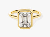 Emerald cut diamond ring in yellow gold bezel setting