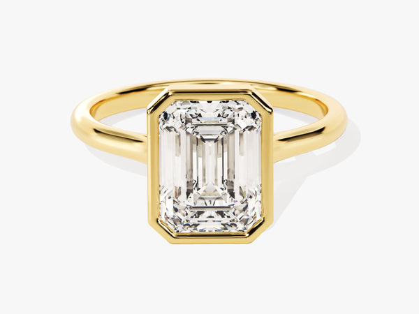 Emerald cut diamond ring in yellow gold bezel setting