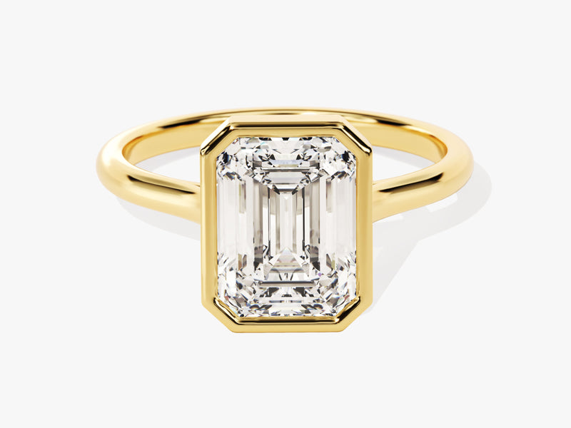 Emerald cut diamond ring in a gold bezel setting