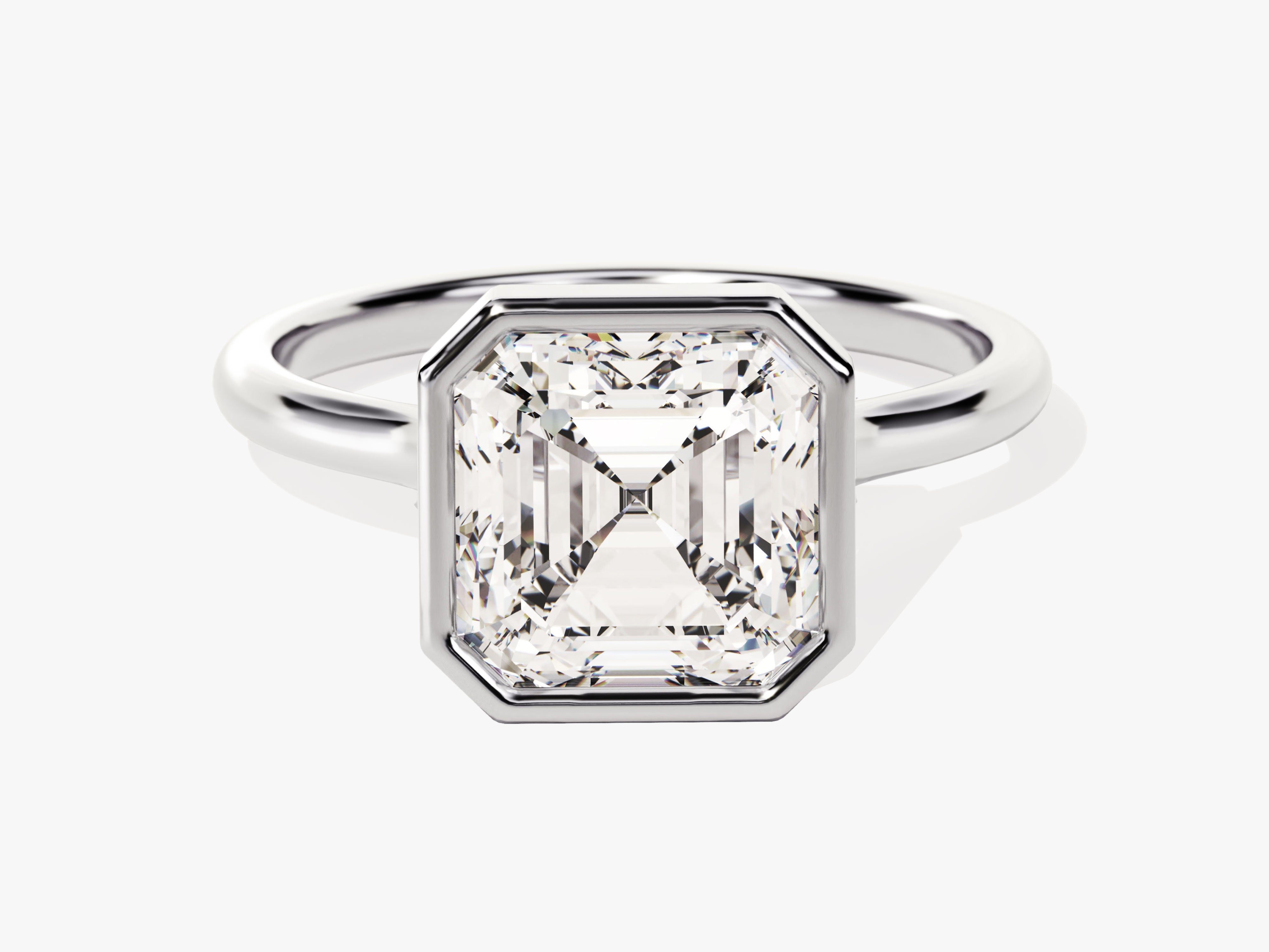 Emerald cut diamond ring in platinum bezel setting