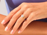 Gold heart ring with diamond on hand