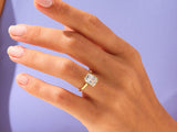 Gold ring with emerald cut diamond on hand