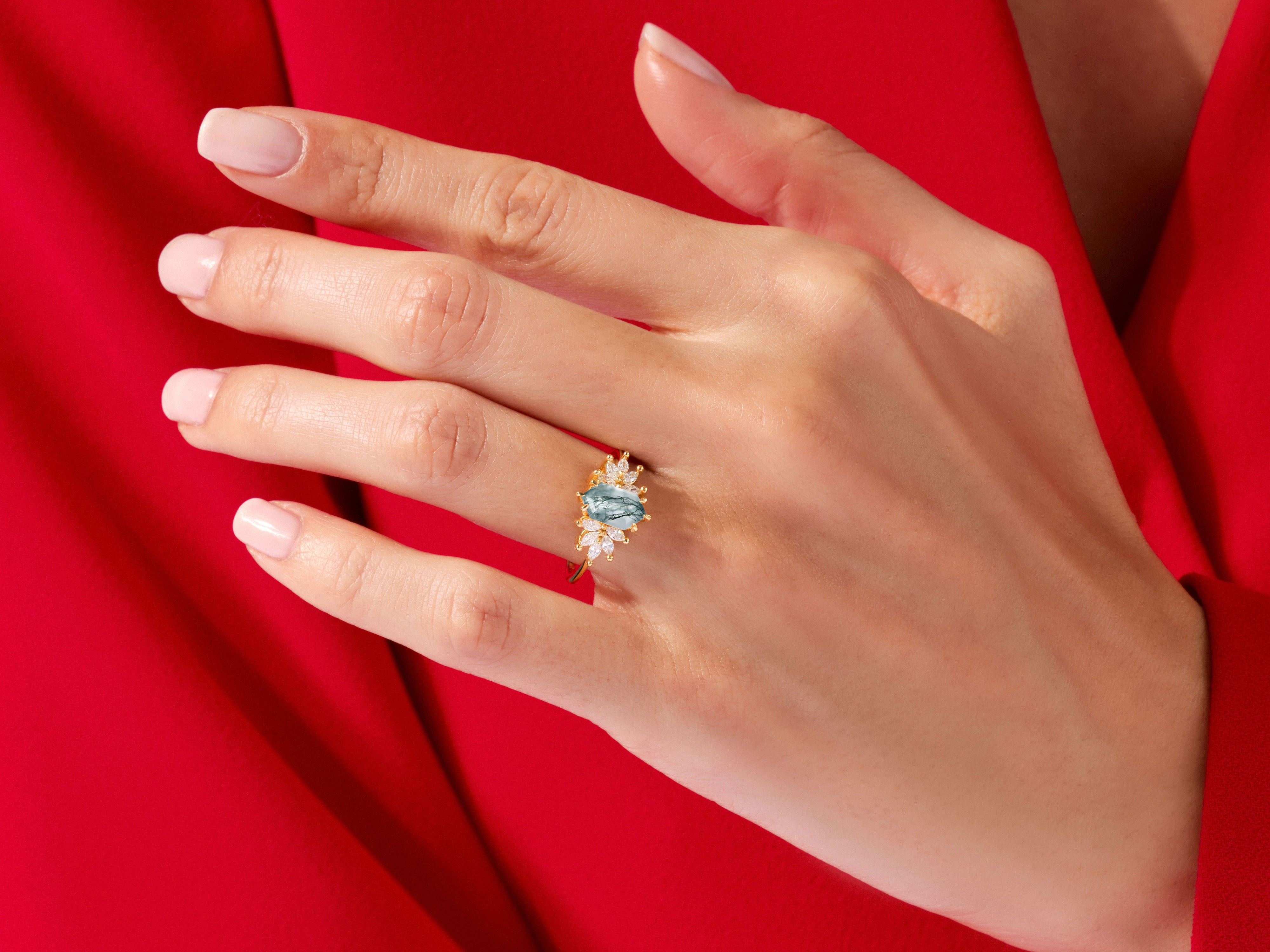 Gold ring with blue stone and diamonds on hand