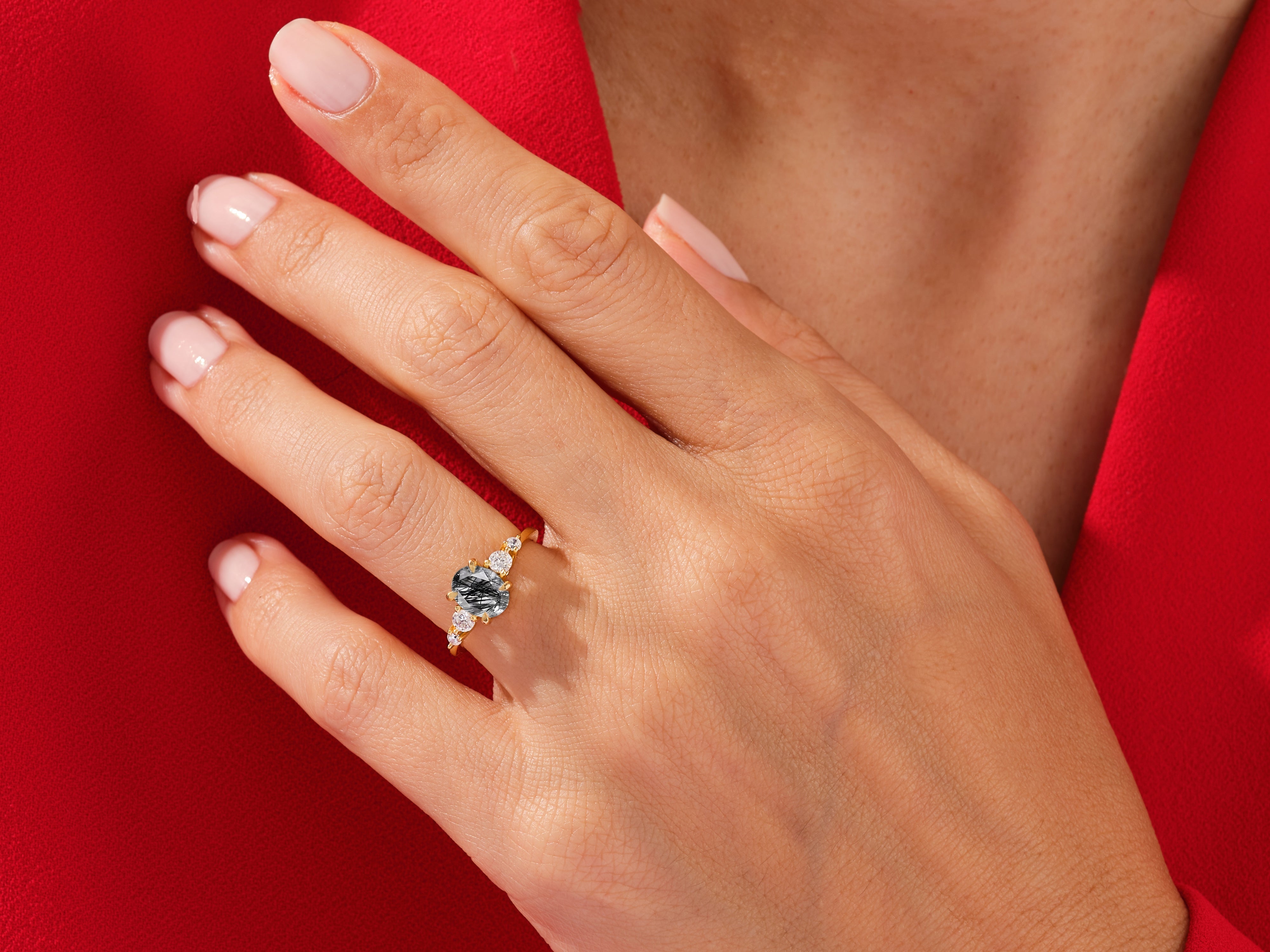 Gold ring with black tourmaline and diamonds on hand