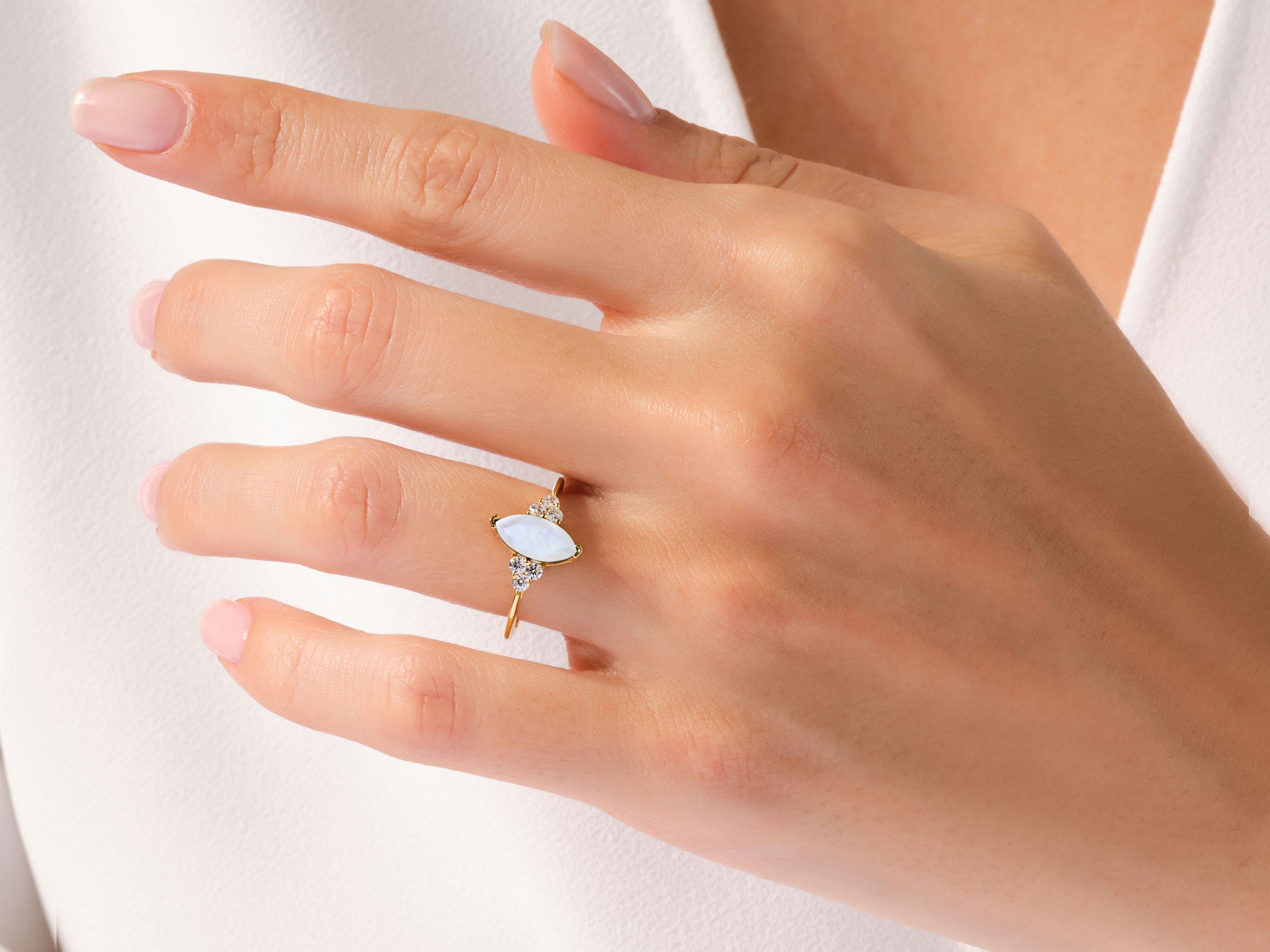 Marquise moonstone and diamond ring on a woman's finger