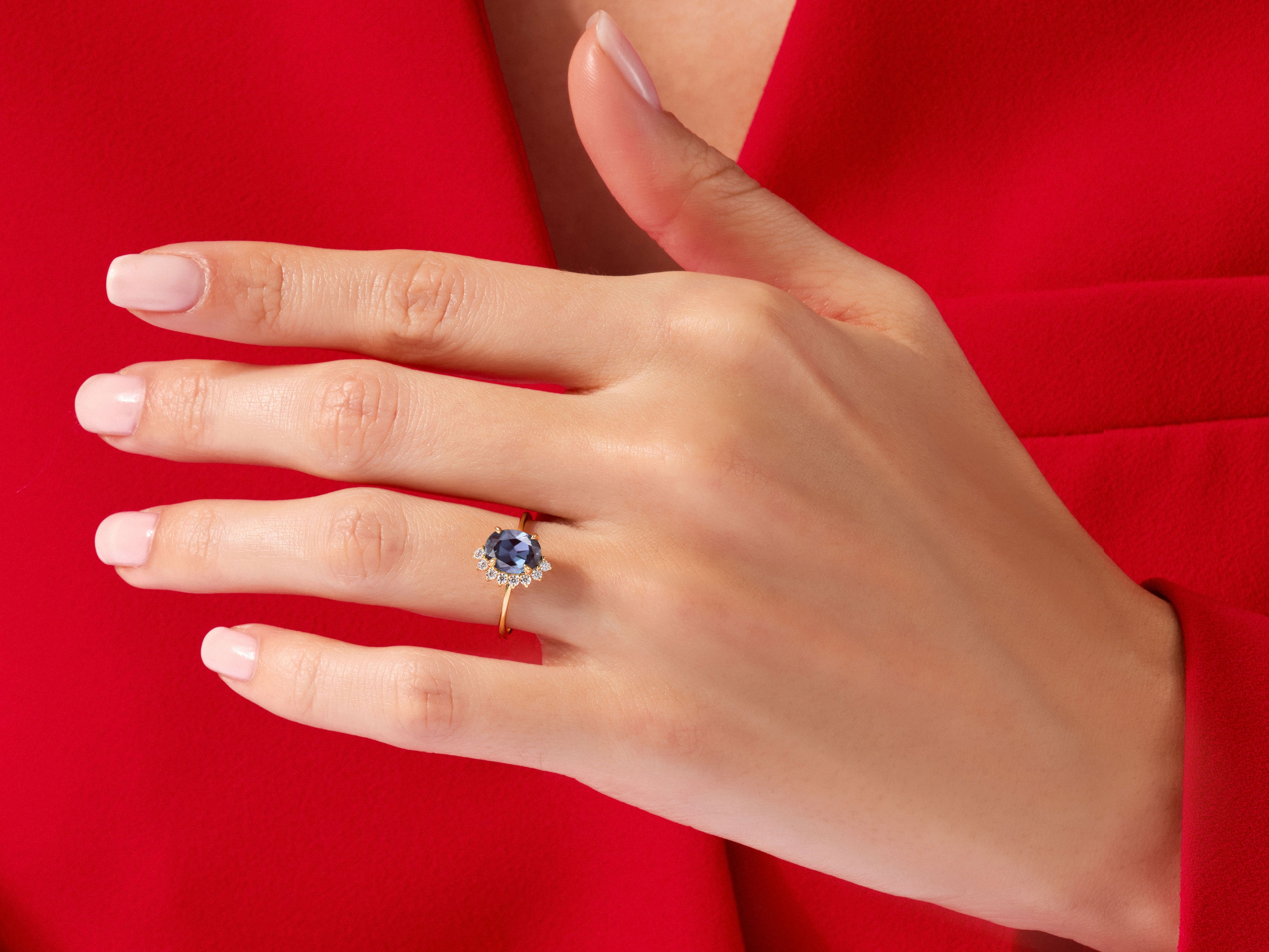 Diamond and sapphire engagement ring on a hand