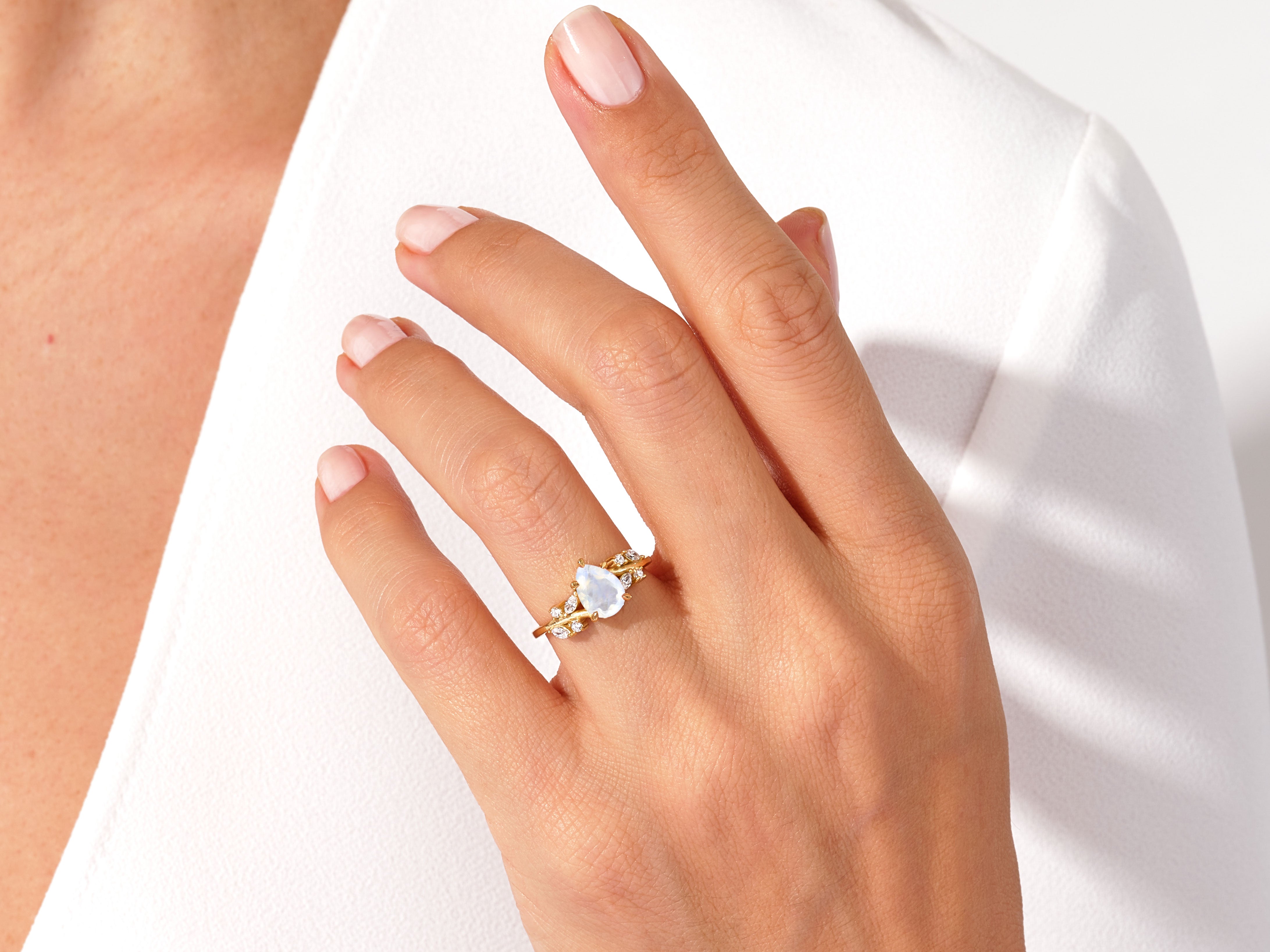 Gold ring with moonstone and diamonds on hand