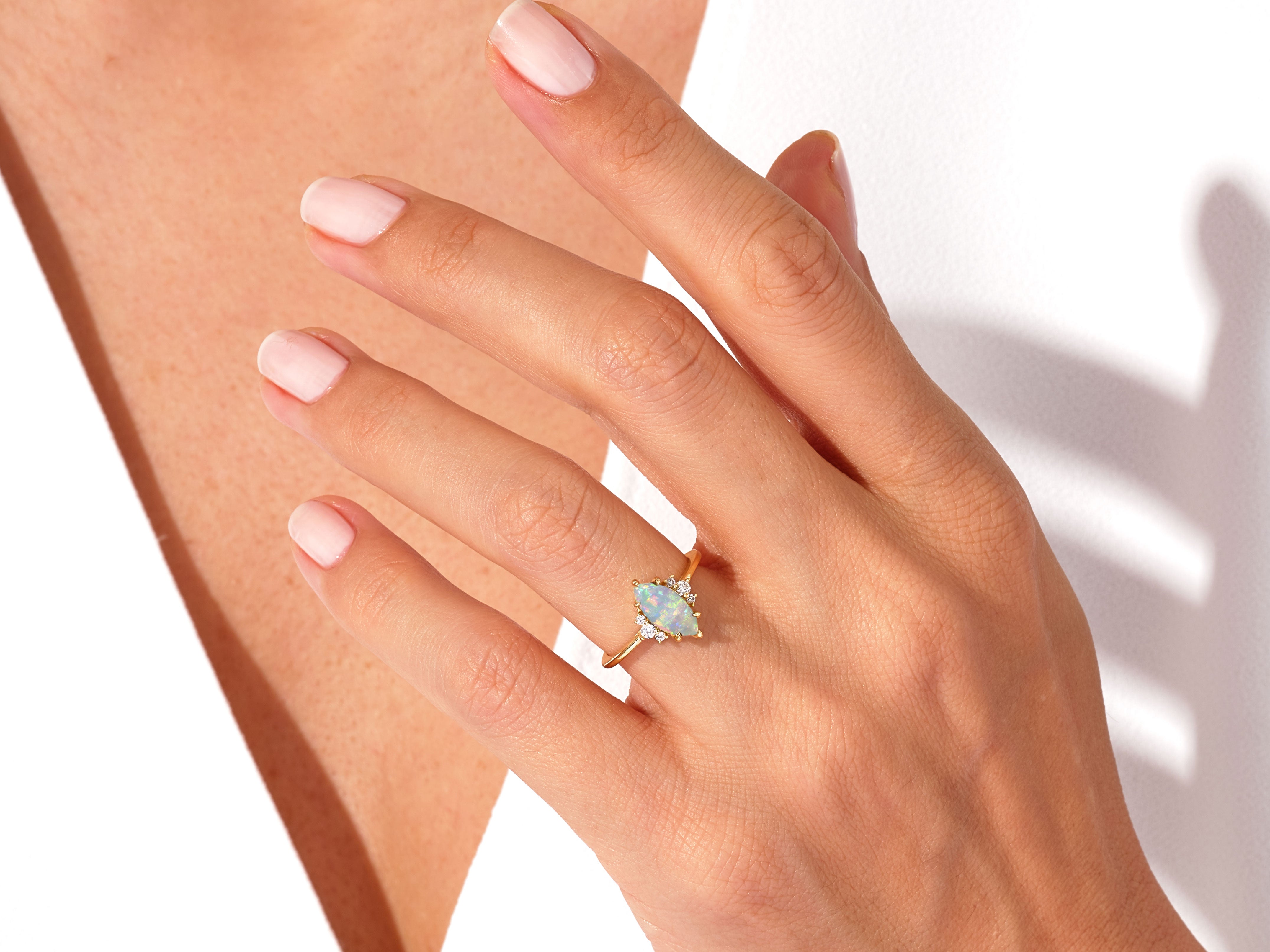 Gold opal diamond ring on a woman's hand