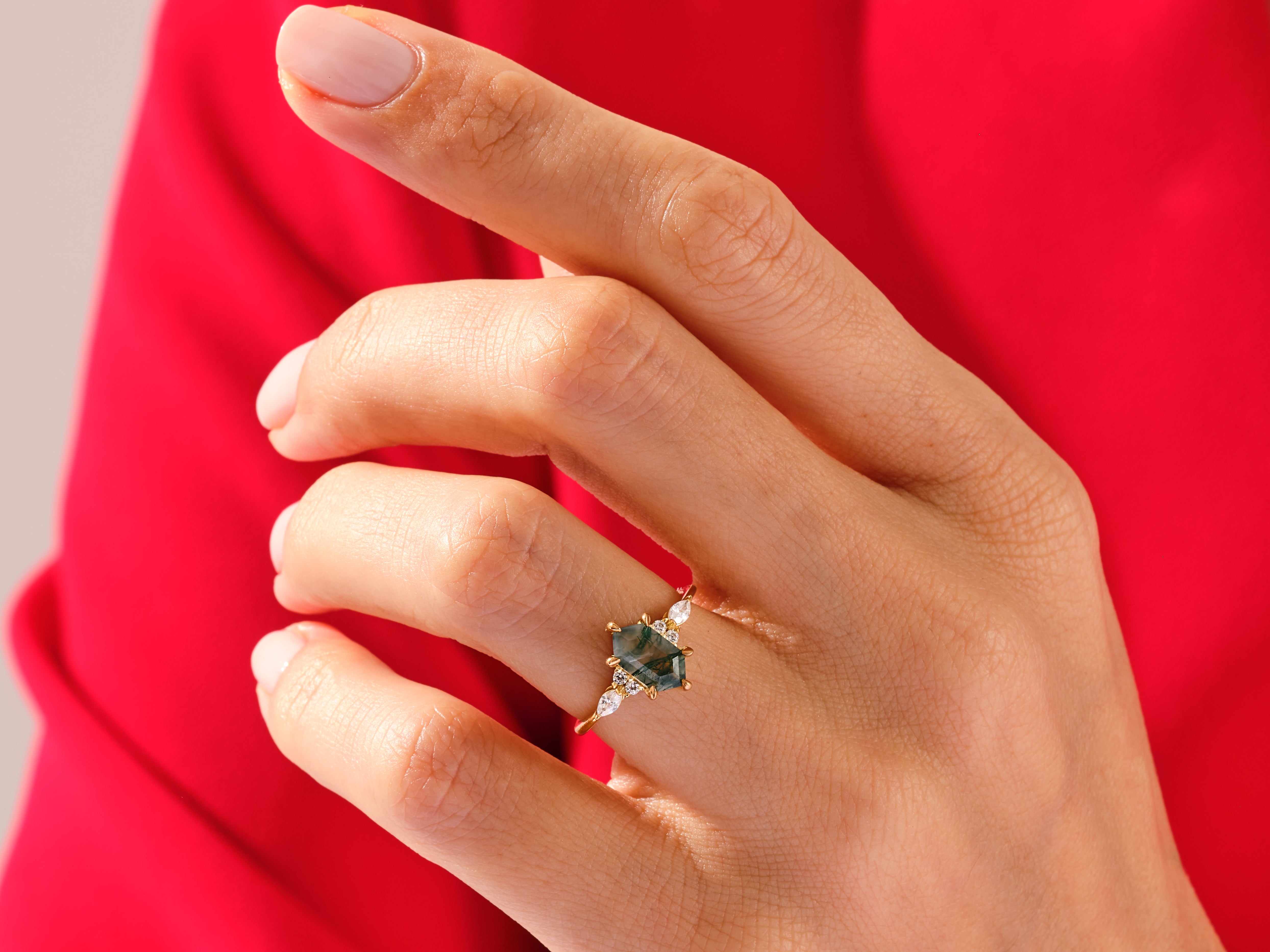Gold ring with hexagon moss agate and diamonds on a hand