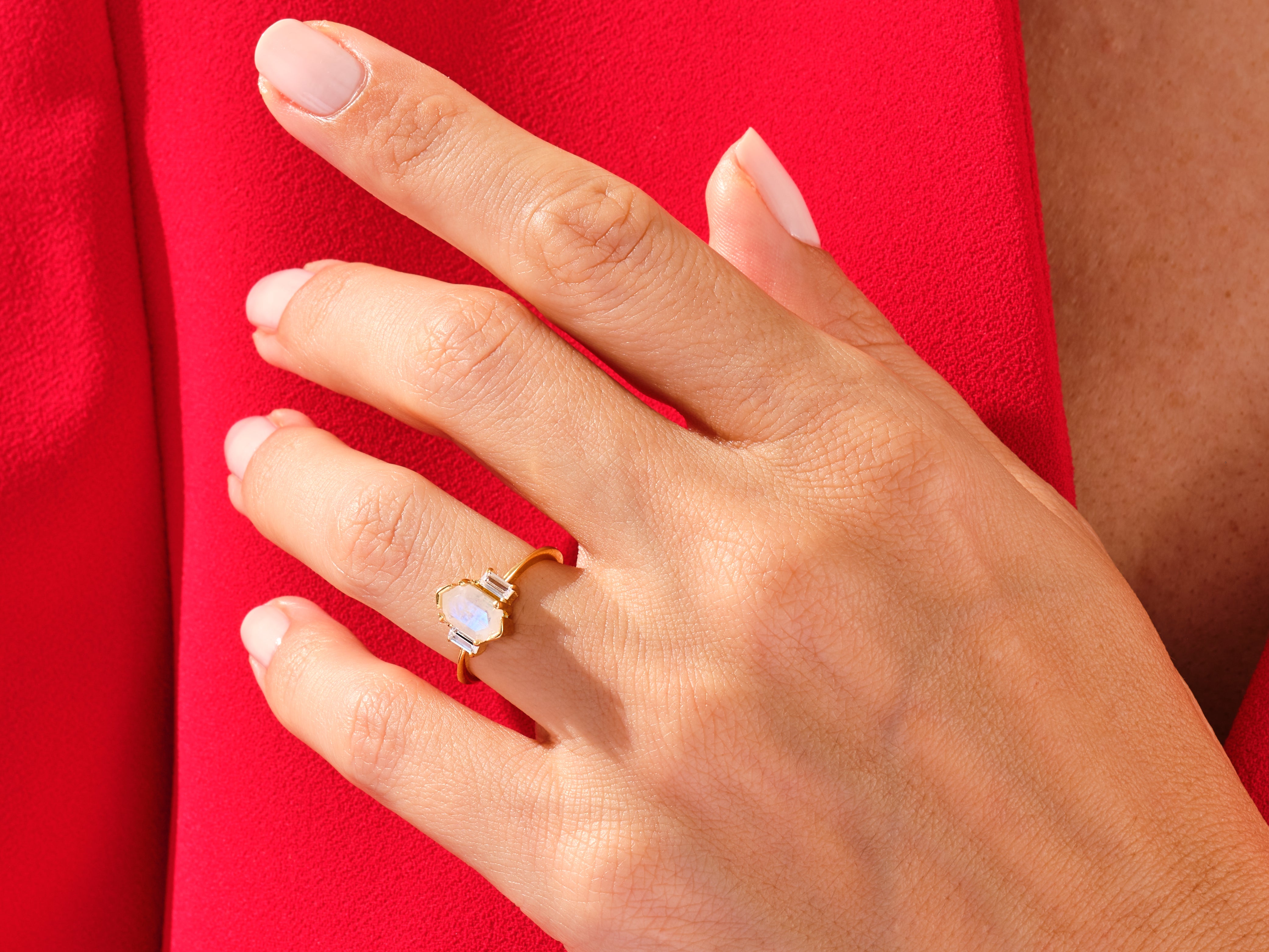 Gold ring with moonstone and diamonds on hand