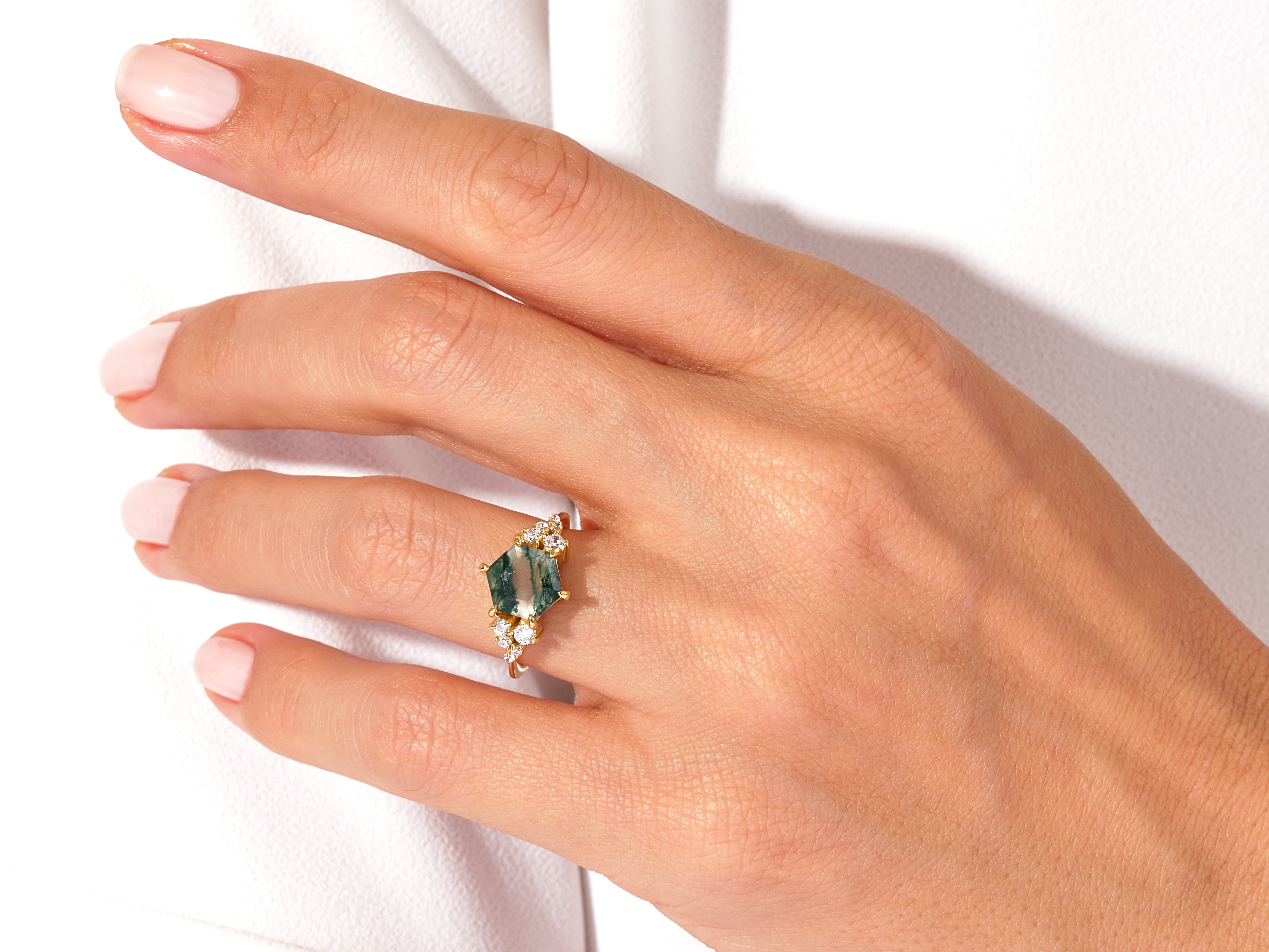 Gold ring with moss agate and diamonds on hand