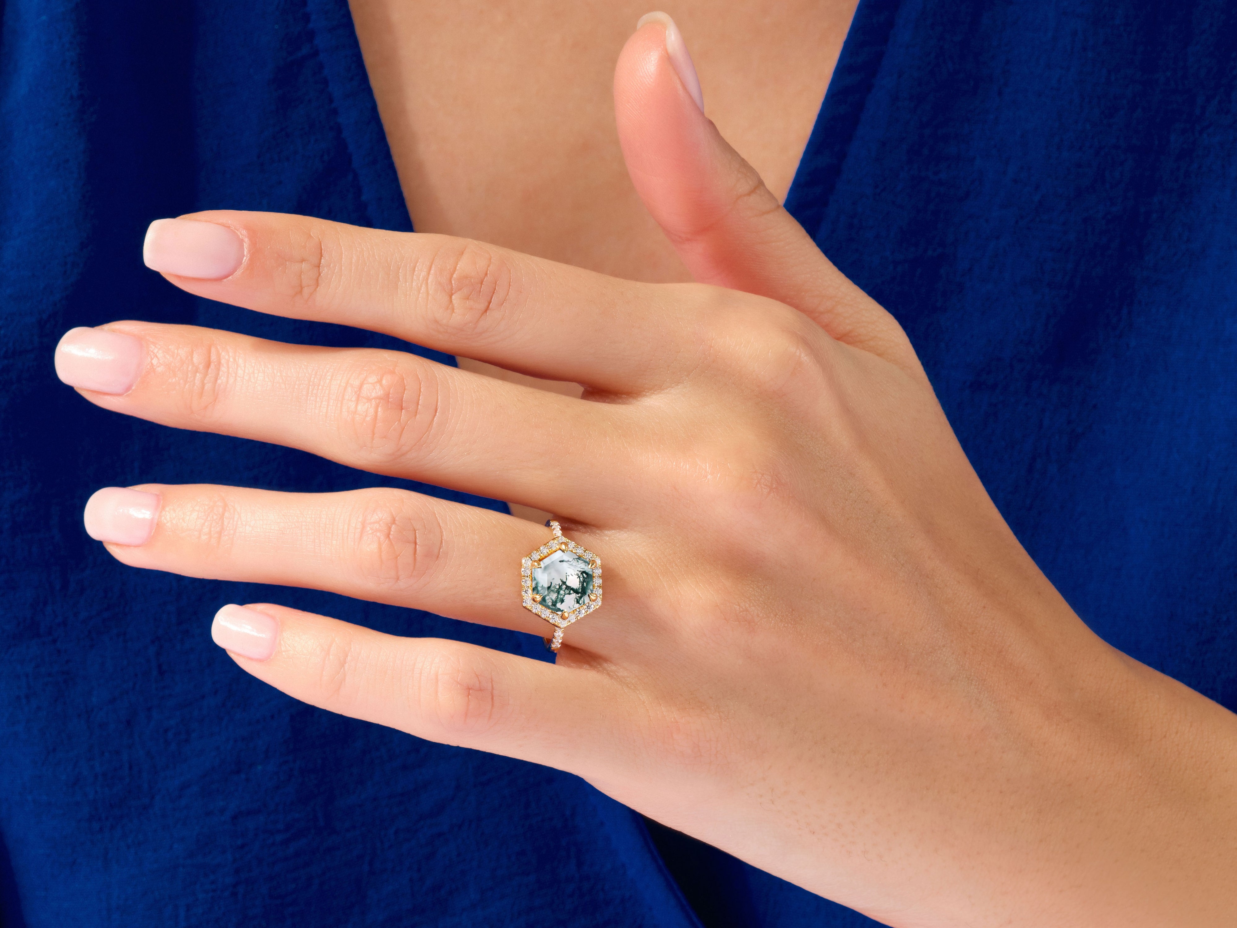 Hexagonal moss agate diamond ring on a woman's hand
