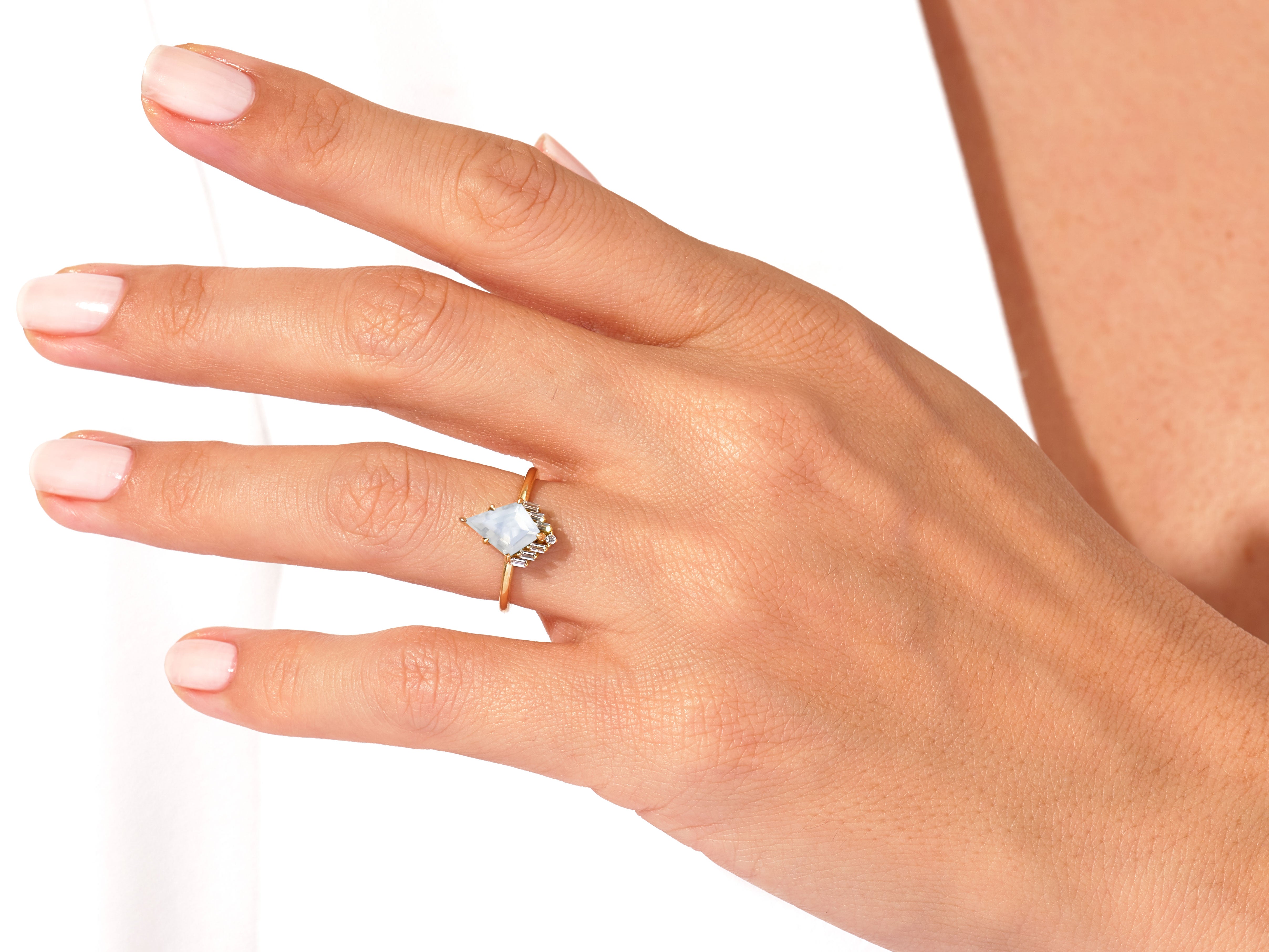Jewelry: Kite-shaped gemstone ring with diamonds on a woman's hand