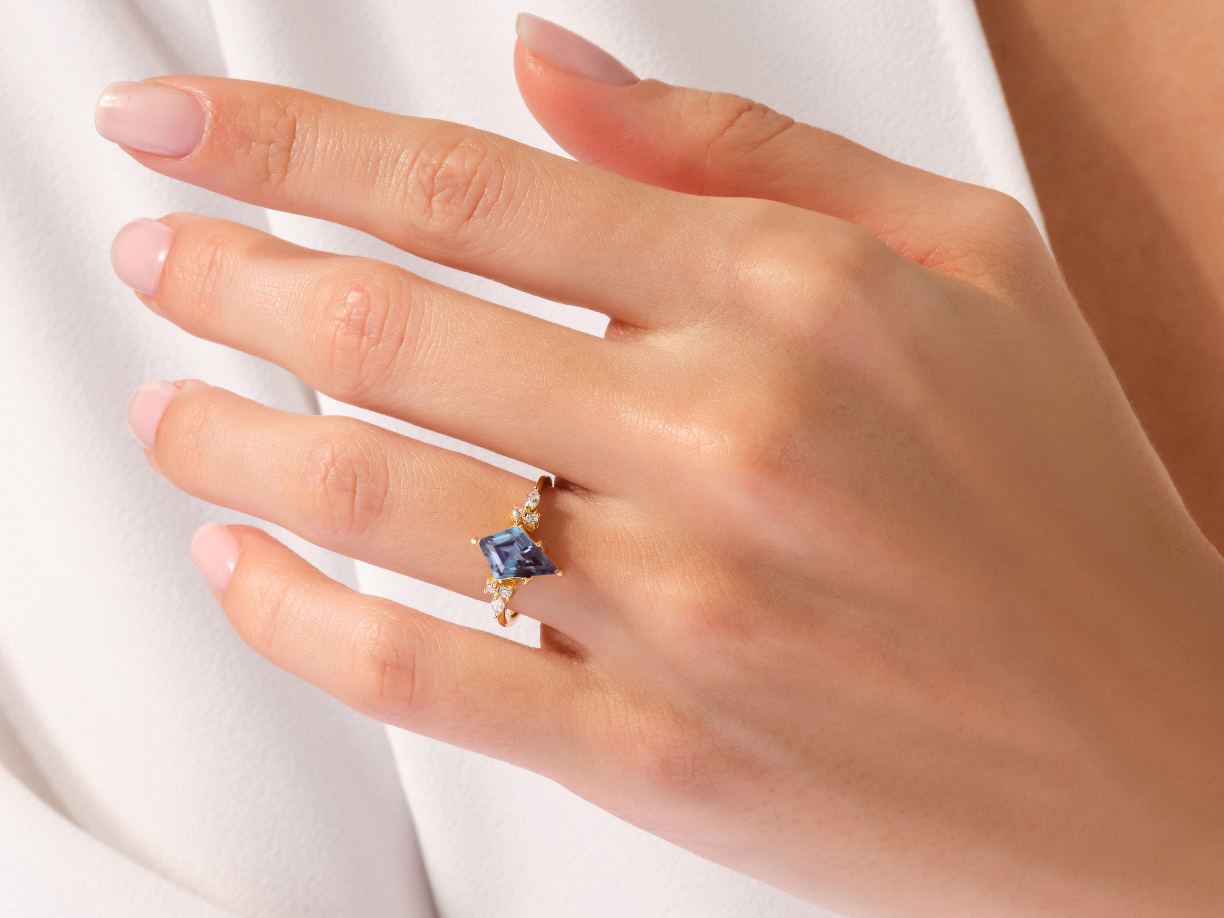 Jewelry: Kite-cut blue gemstone ring with diamonds on hand