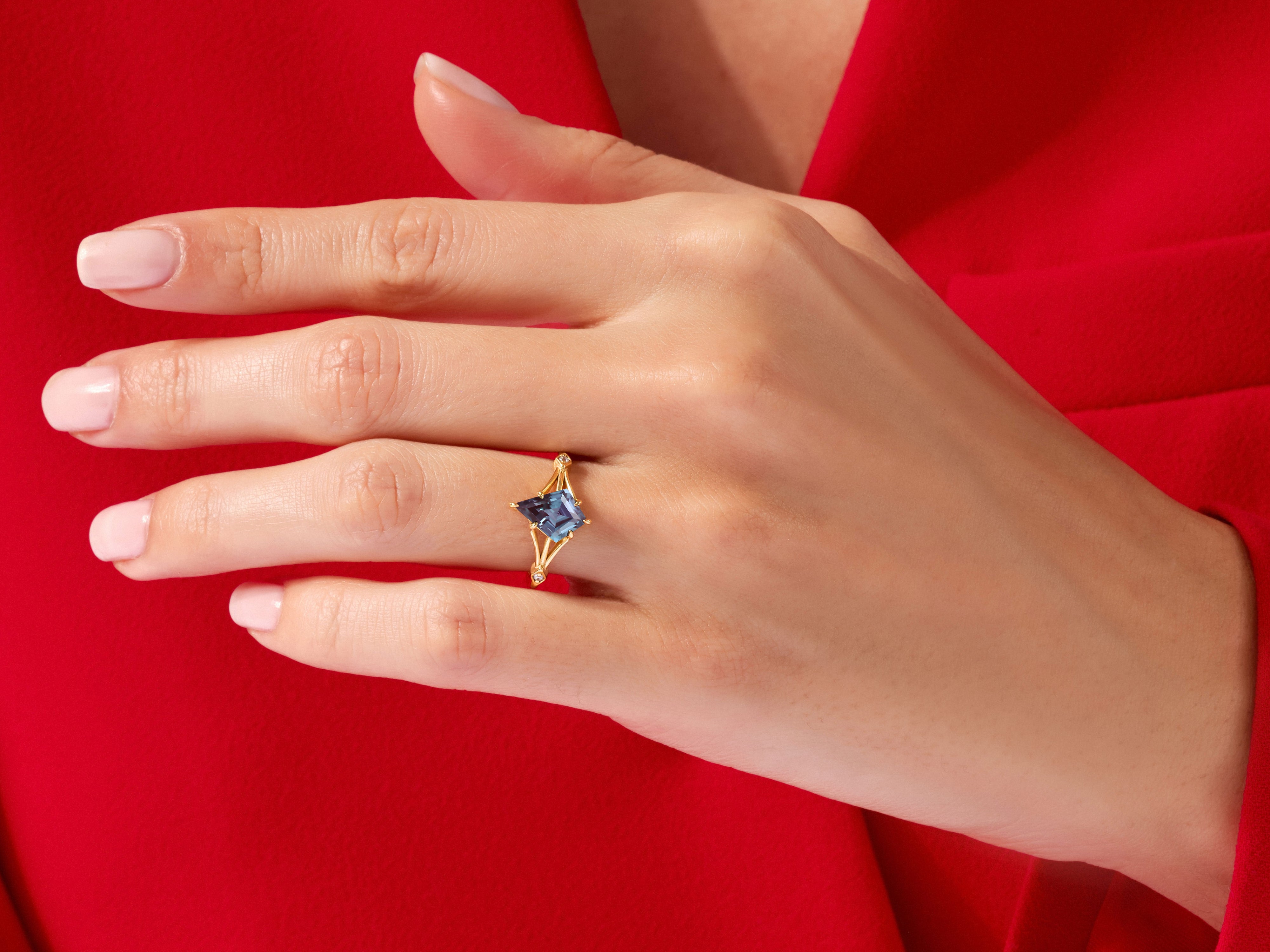 Gold ring with blue gemstone on hand, jewelry
