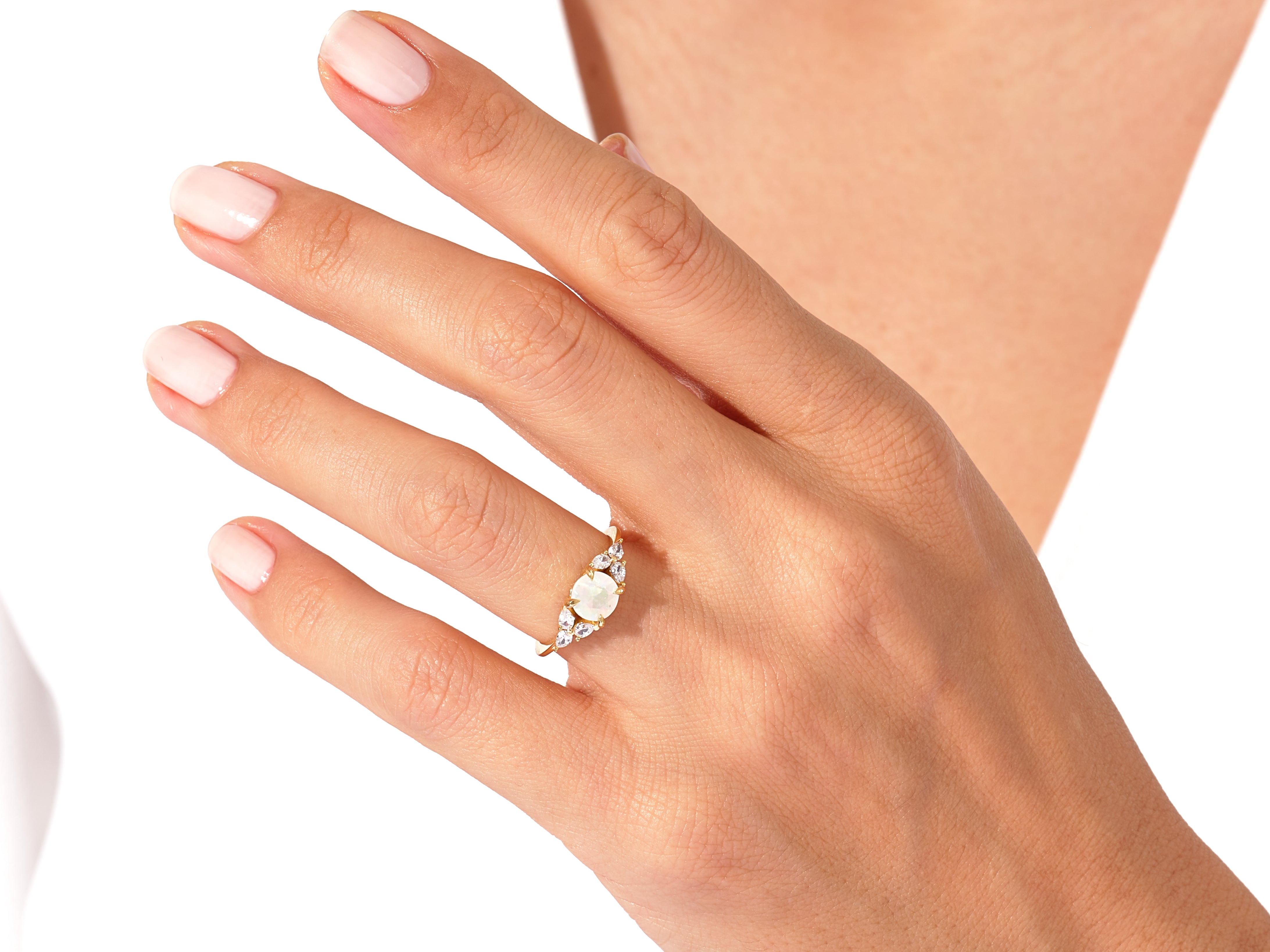 Gold opal and diamond ring on a woman's hand