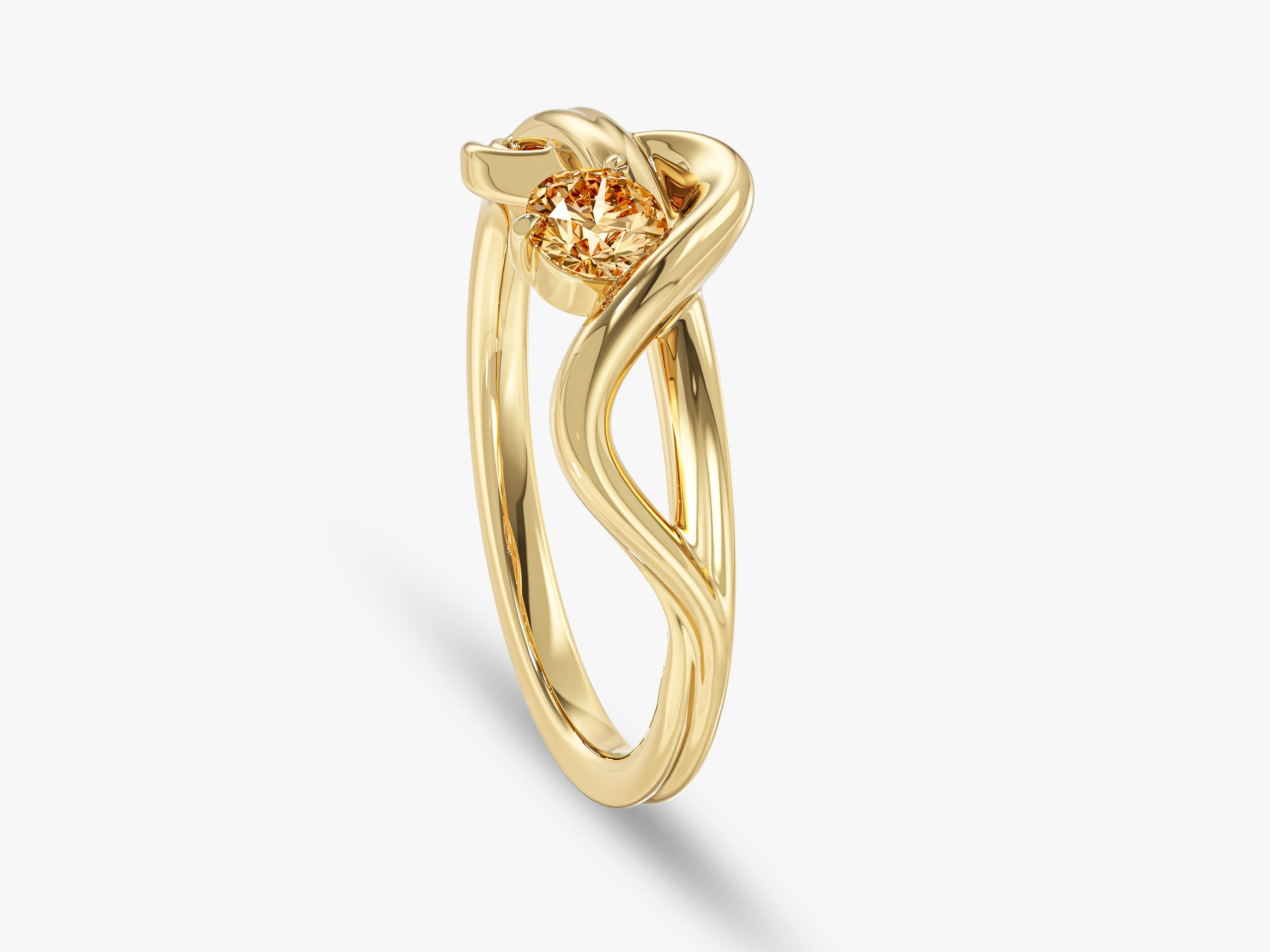 Gold ring with a unique twisted band and a sparkling champagne diamond
