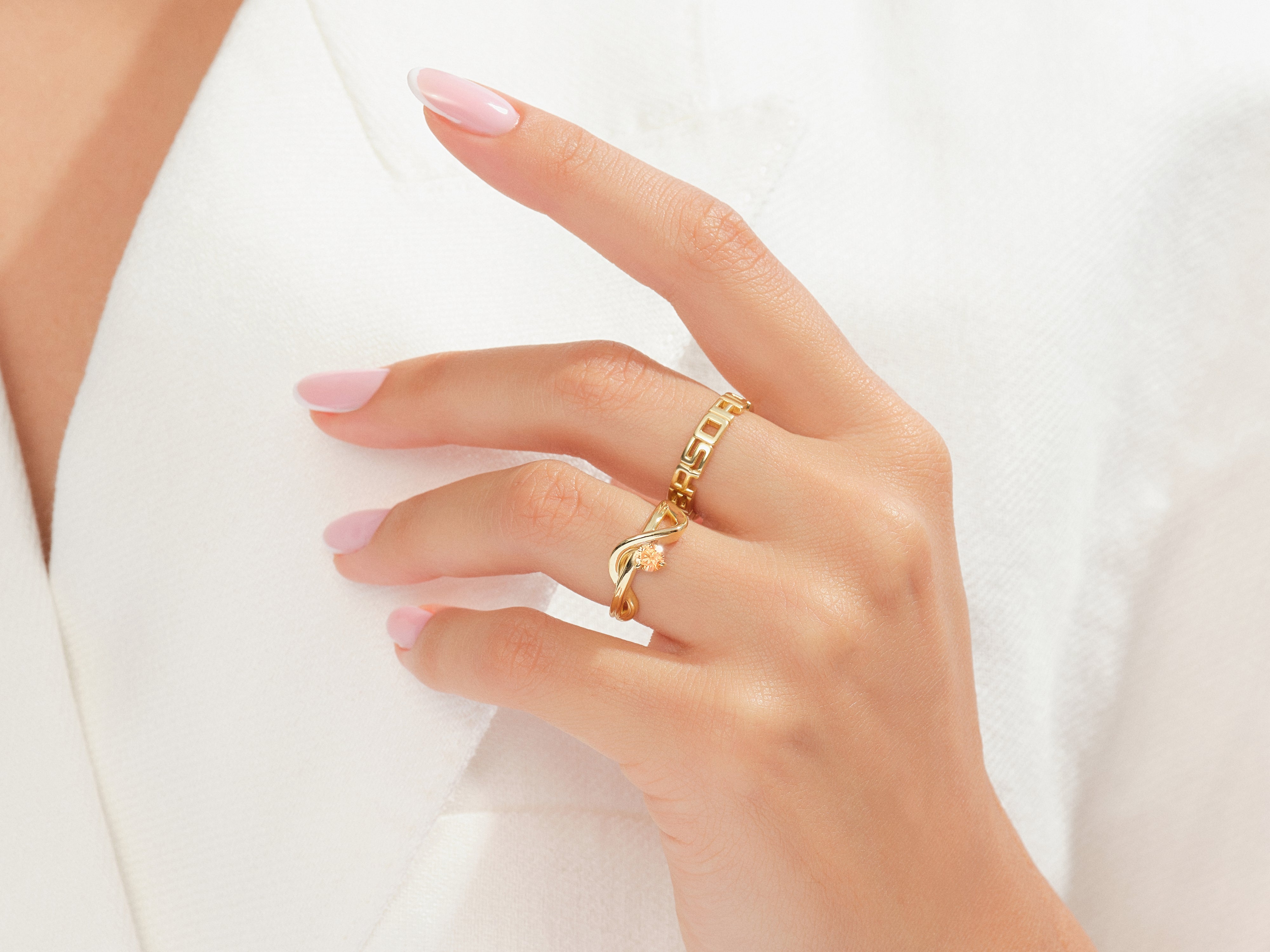Elegant gold rings on a hand, showcasing fine jewelry craftsmanship
