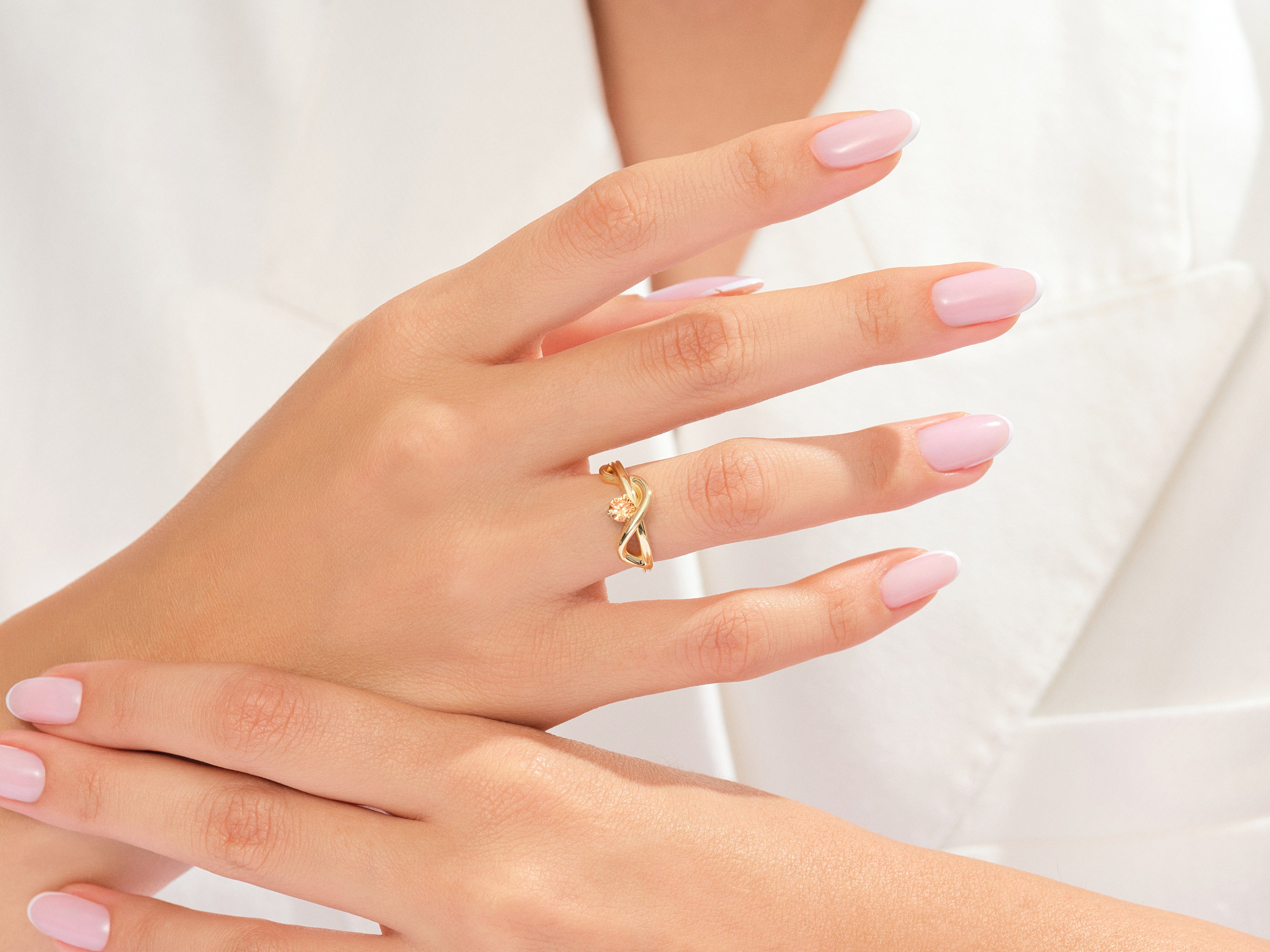 Elegant gold ring with diamond accent on a woman's hand