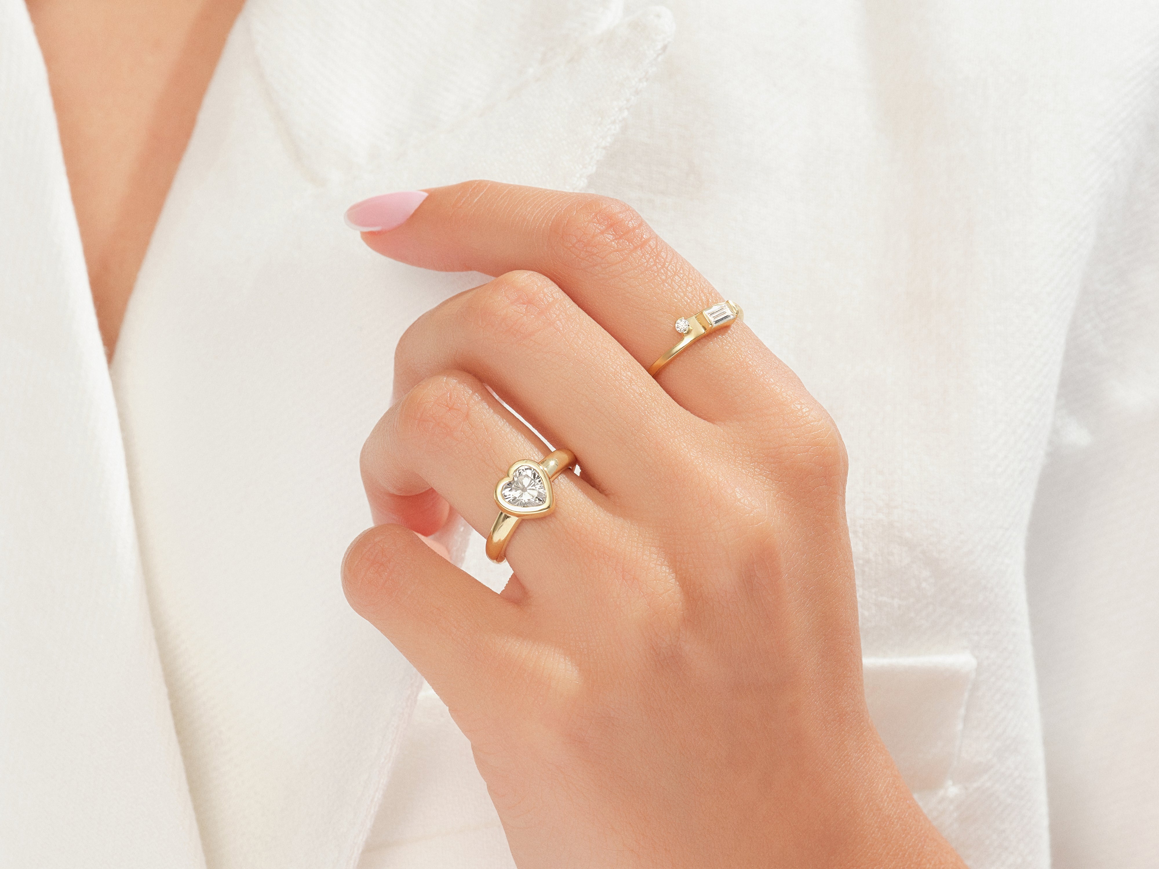 Gold rings with diamonds on a hand, jewelry photography