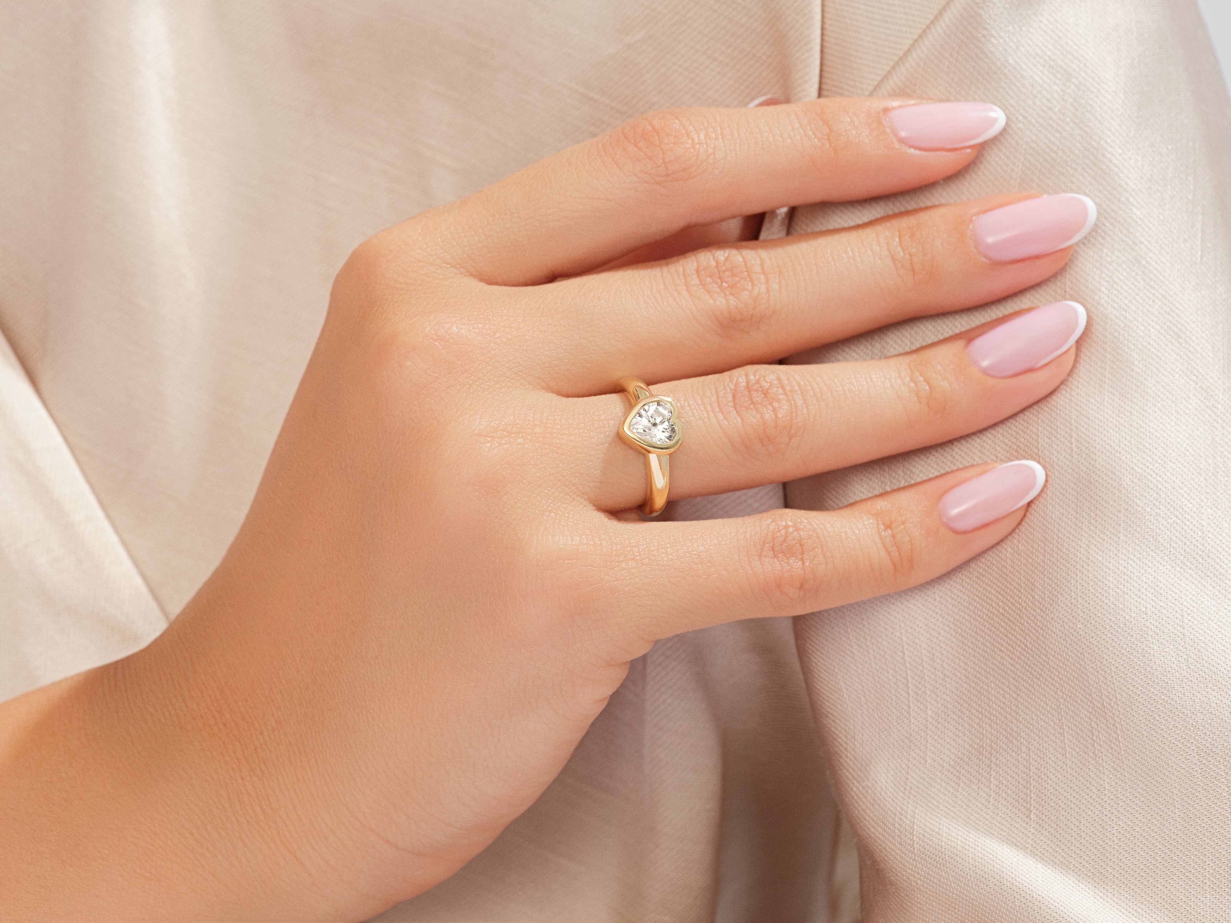 Gold heart diamond ring on a woman's hand