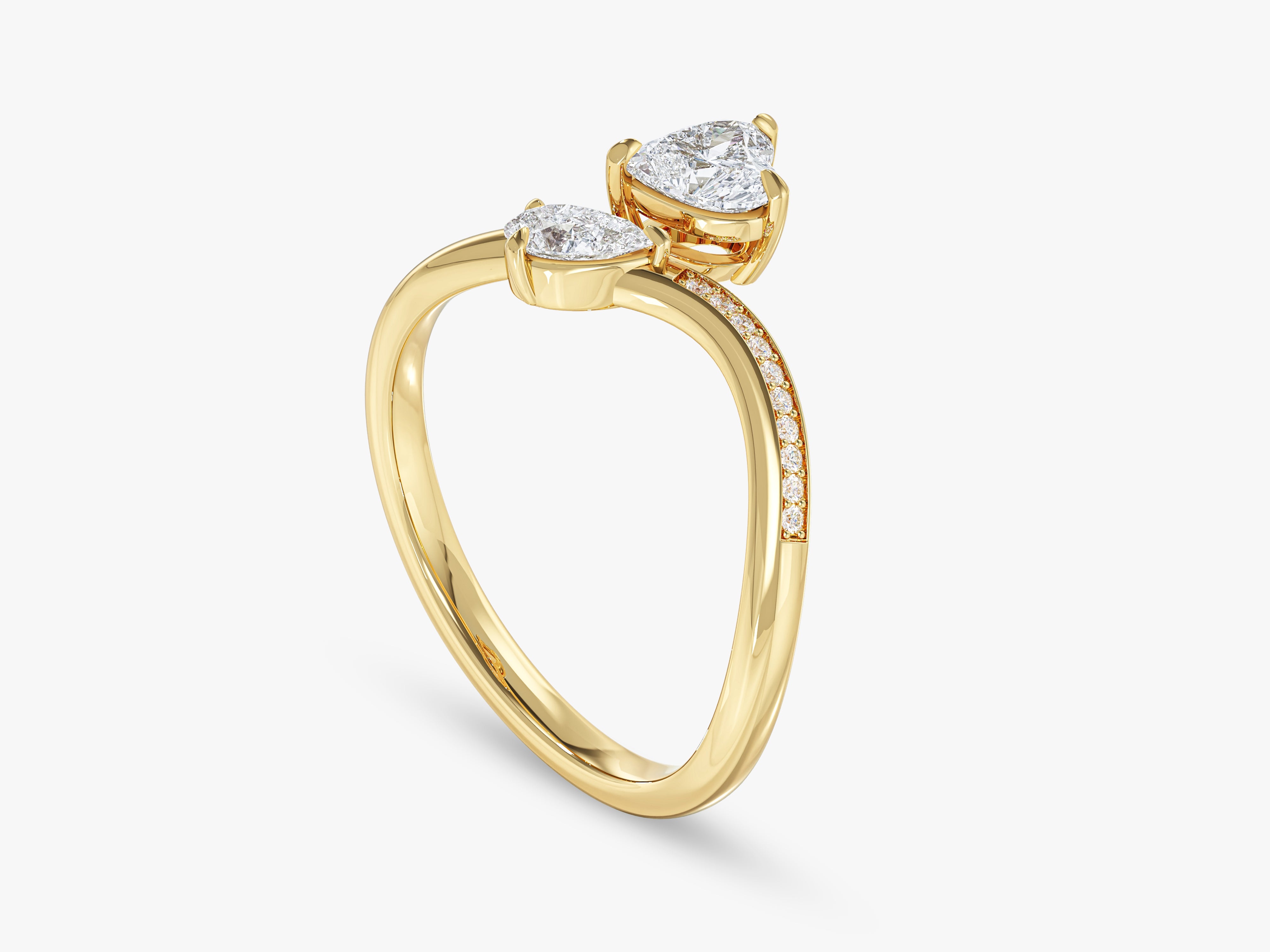 Gold bypass ring with pear-shaped diamonds and pave accents