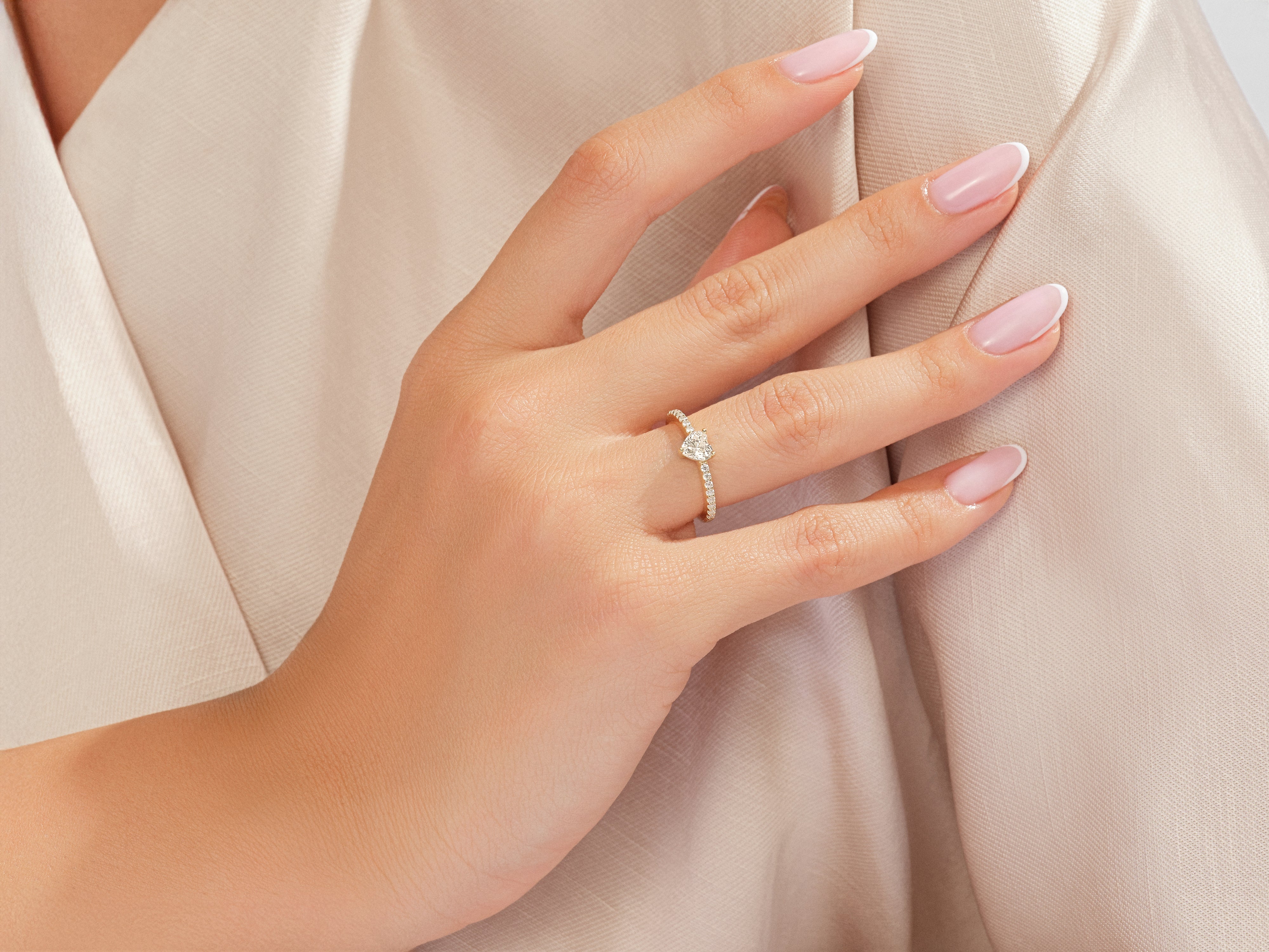 Heart-shaped diamond ring on a woman's finger, fine jewelry