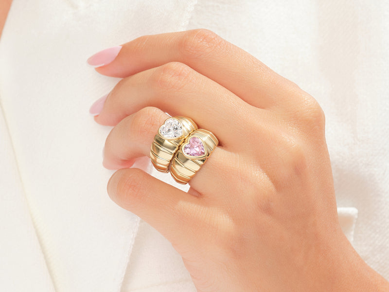 Gold heart rings with diamond and pink sapphire on hand