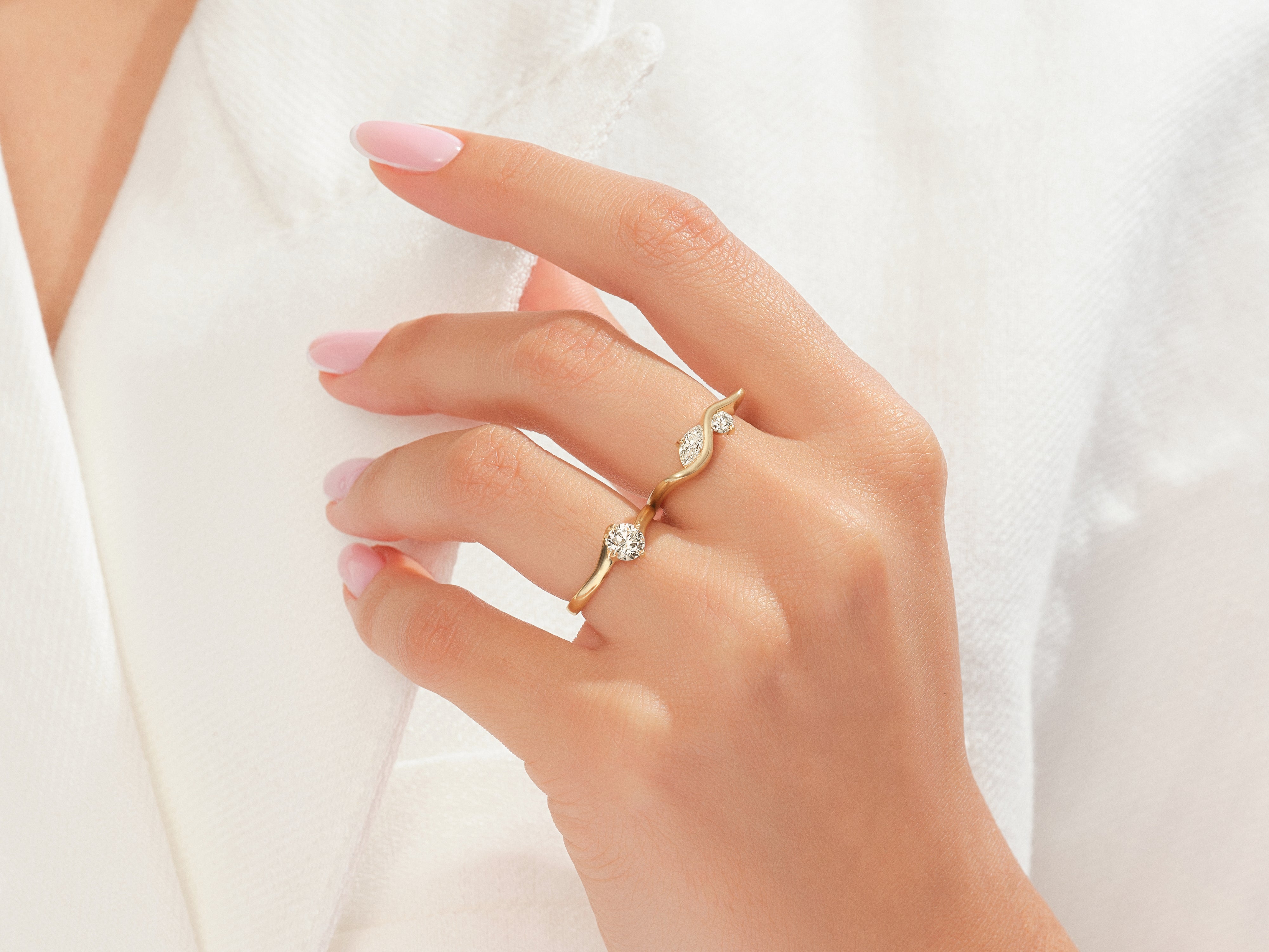 Diamond and gold rings on a woman's hand