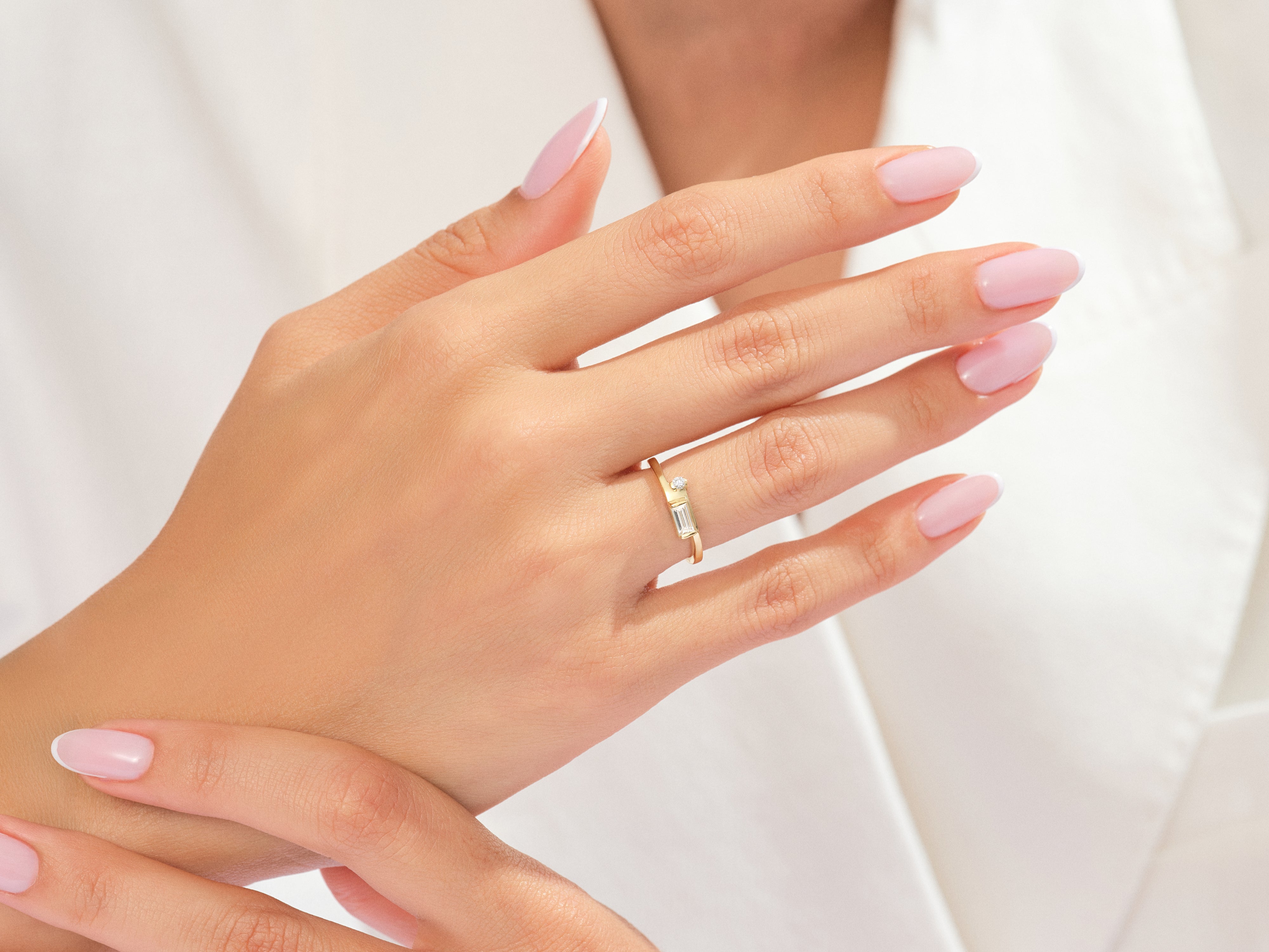 Gold ring with baguette and round diamonds on a woman's hand