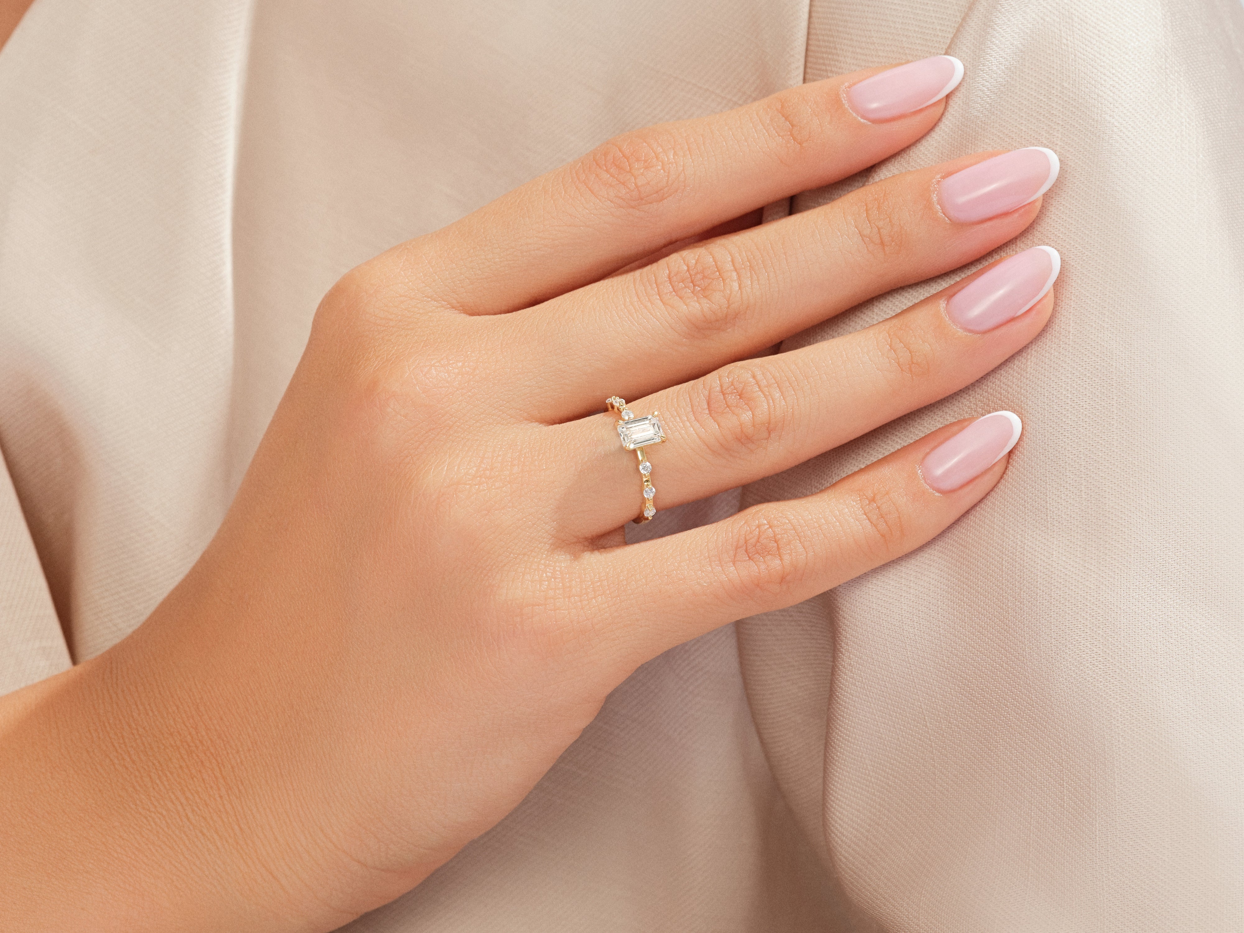 Elegant emerald cut diamond ring on a woman's hand