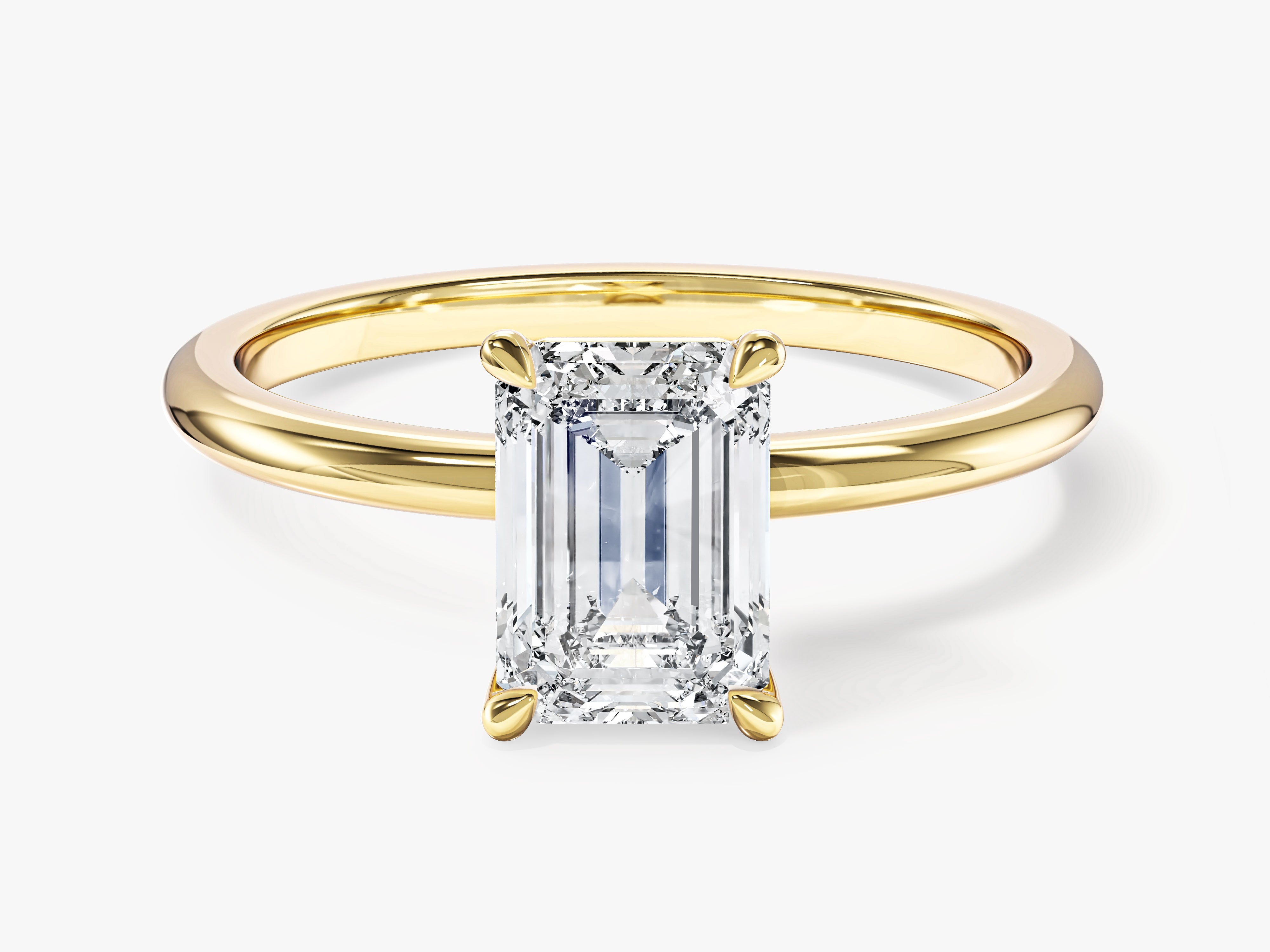 Emerald cut diamond ring in yellow gold setting