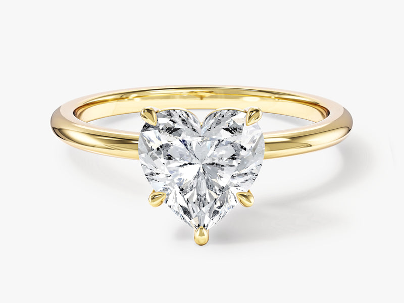 Gold ring with heart-shaped diamond engagement ring