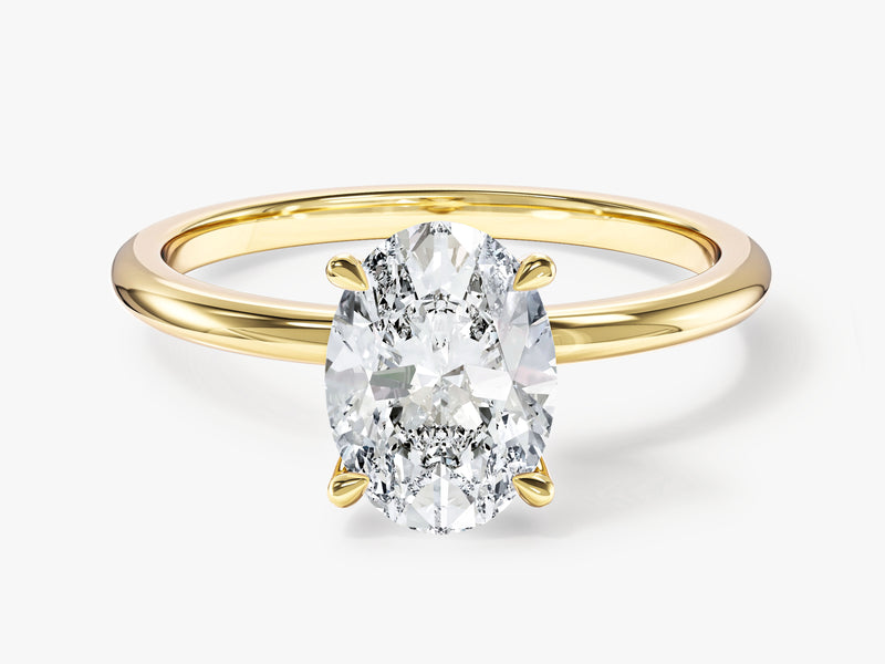 Oval diamond engagement ring in yellow gold setting
