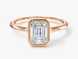 Emerald cut diamond ring in rose gold bezel setting