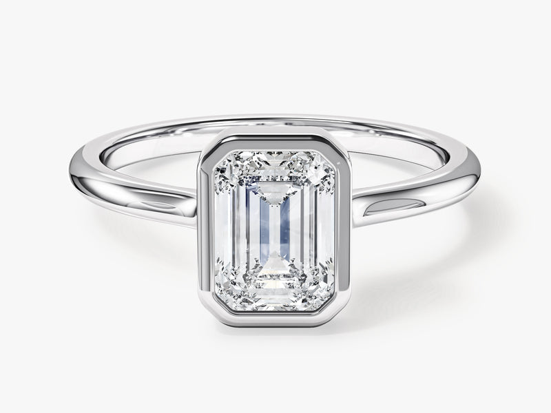 Emerald cut diamond engagement ring in a bezel setting
