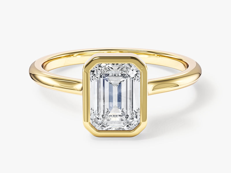 Emerald cut diamond ring in a gold bezel setting