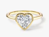 Gold ring with heart-shaped diamond engagement ring